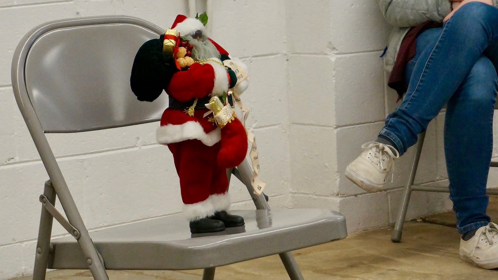 Black Santa rests on a folding chair at a Teacher Story Slam event last month.