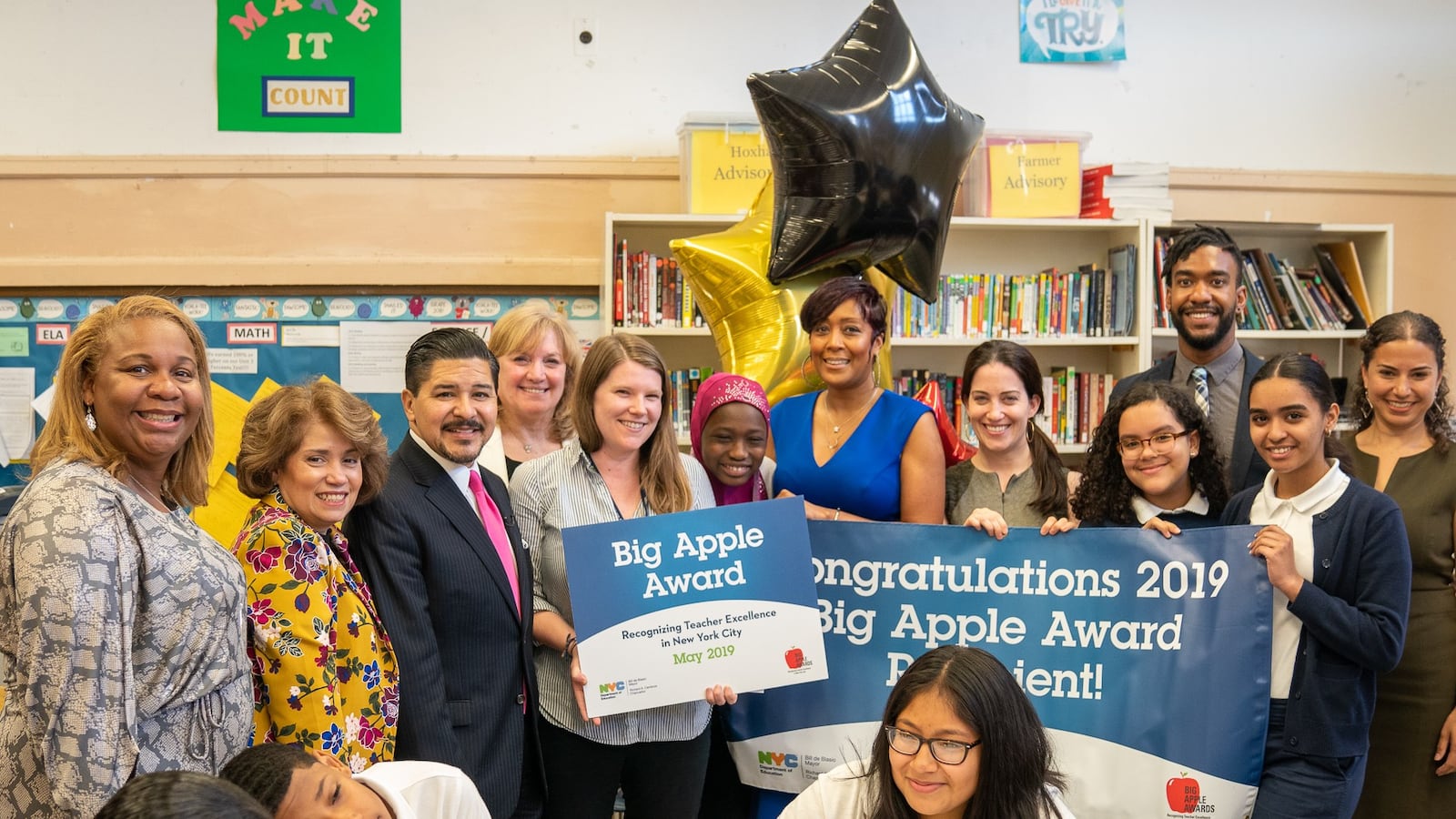 Chancellor Carranza delivers a 'Big Apple' award to Emilie Jones-McAdams, an English teacher at I.S. 303 in the Bronx.
