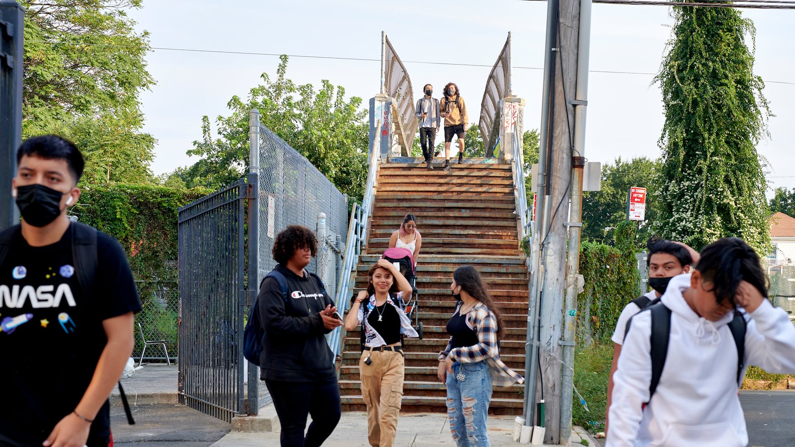 Students descend down a staircase as they make their way toward Pan American High School in Elmhurst.