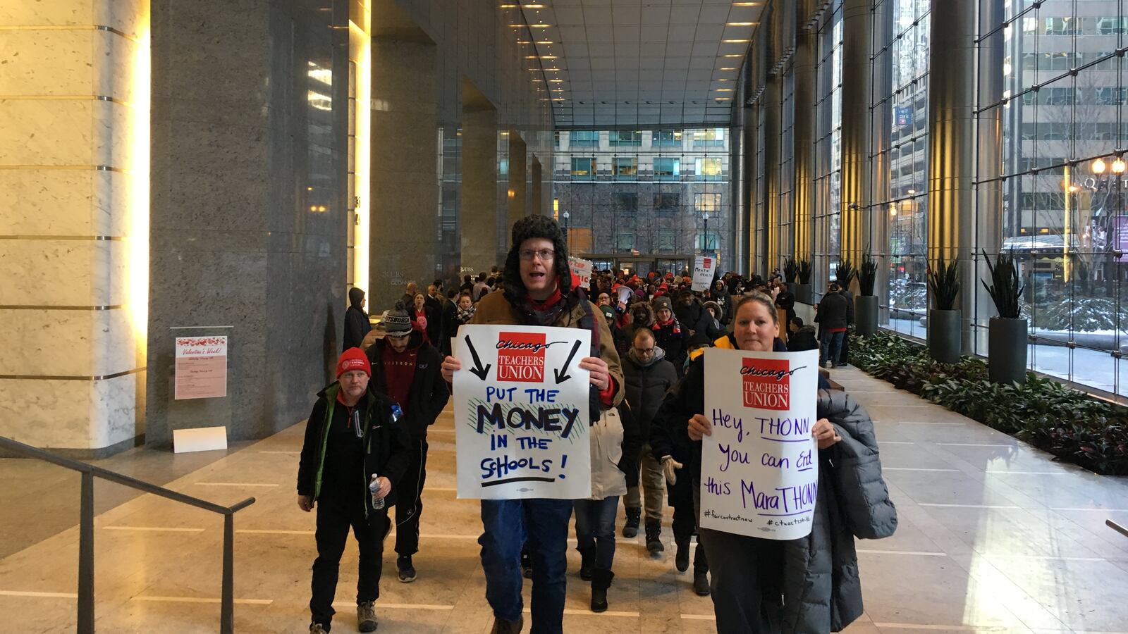 Charter teachers on strike march out of a prominent Loop high-rise following a sit-in blocking entrances and elevators.