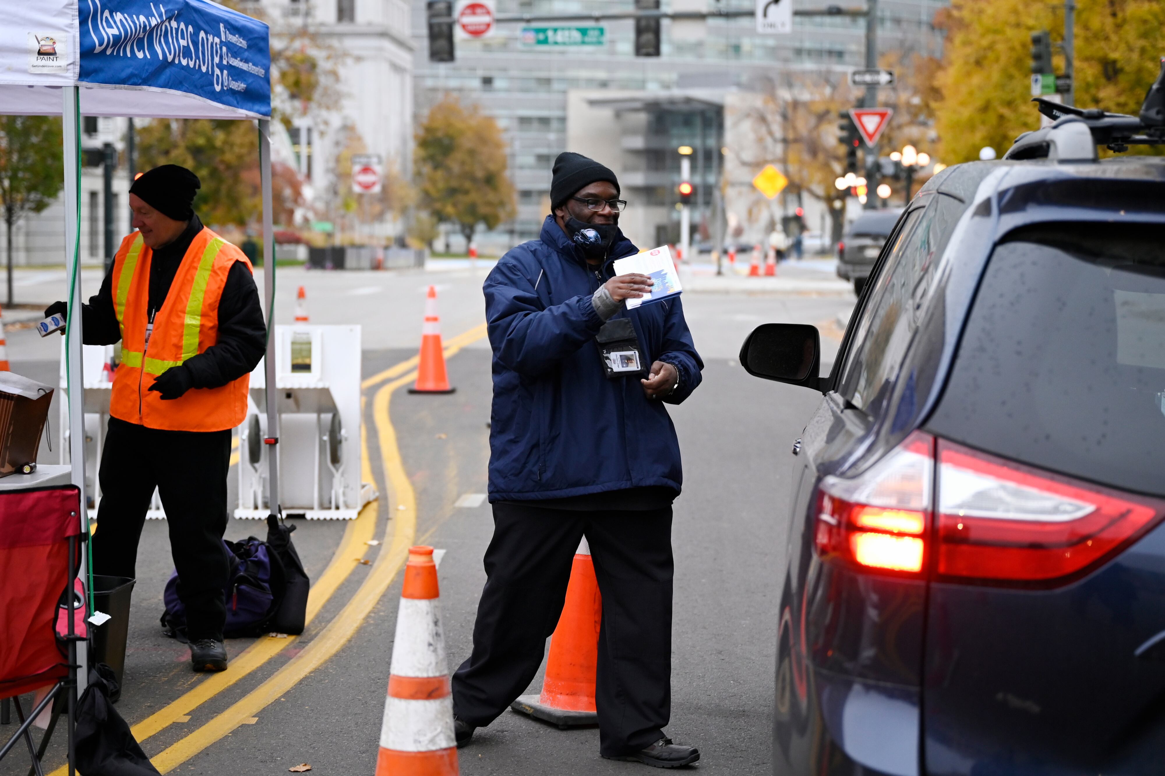 Two election judges interact with voters at a Denver Elections Division polling site.