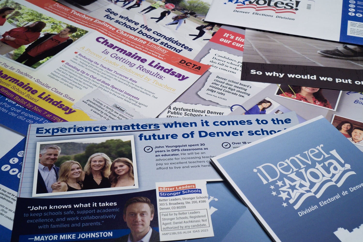 Campaign mailers spread out on a table.