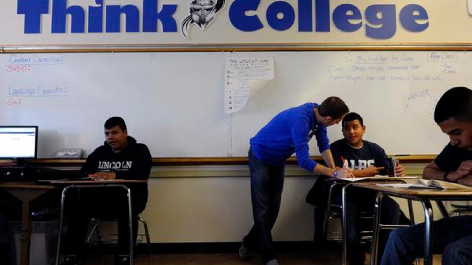 A teacher works with a ninth-grade student at Abraham Lincoln High School in Denver in 2012.