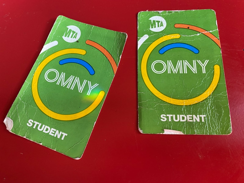 A photograph of two green OMNY student transportation cards