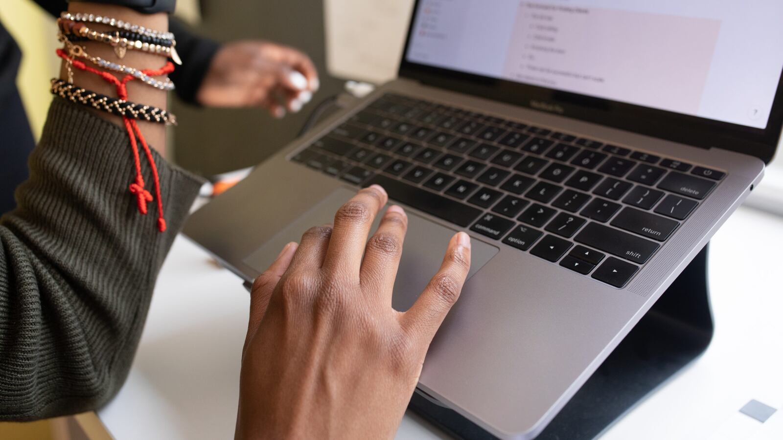 Close up of hands typing on a laptop.