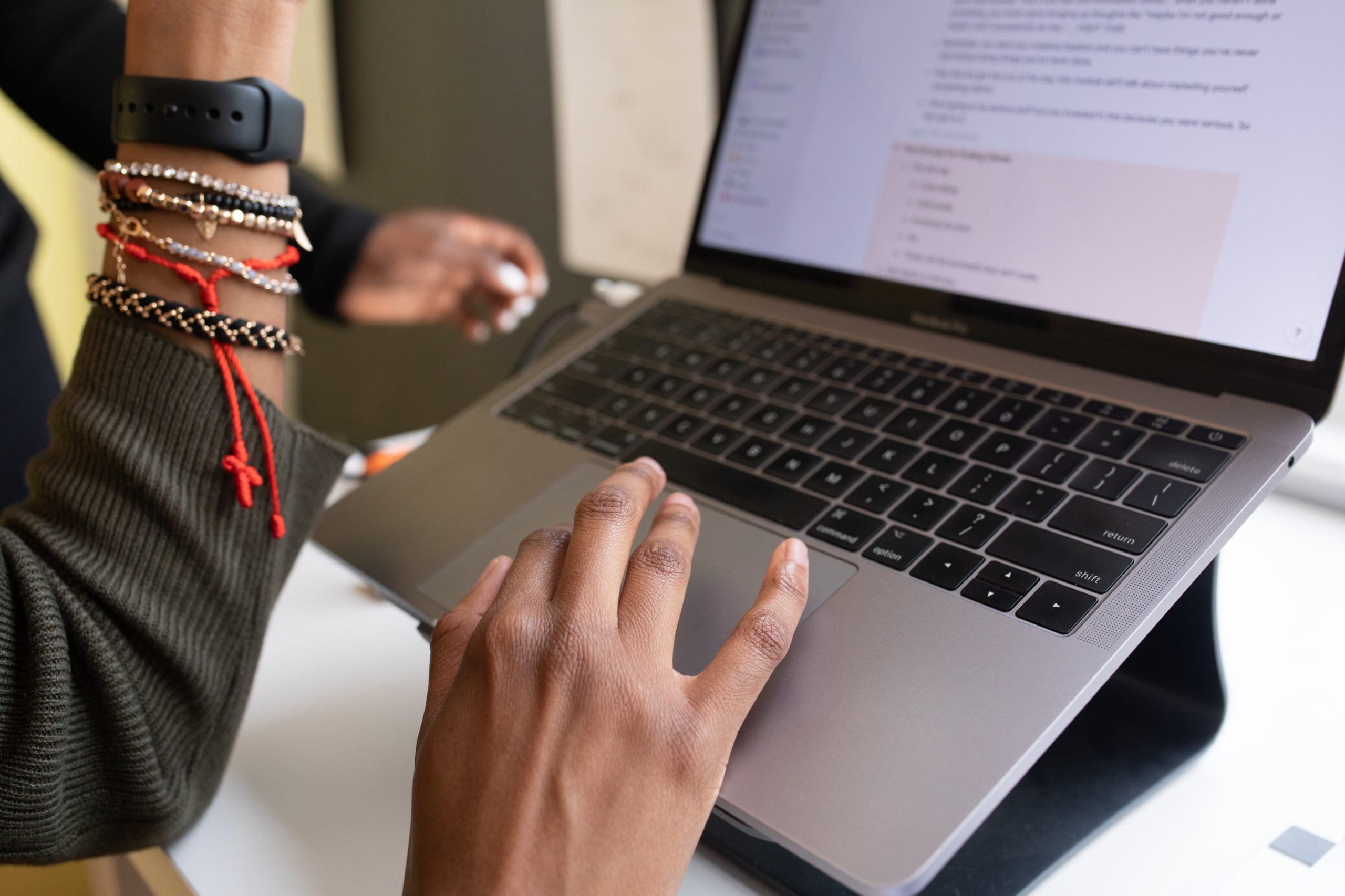 Close up of hands typing on a laptop.