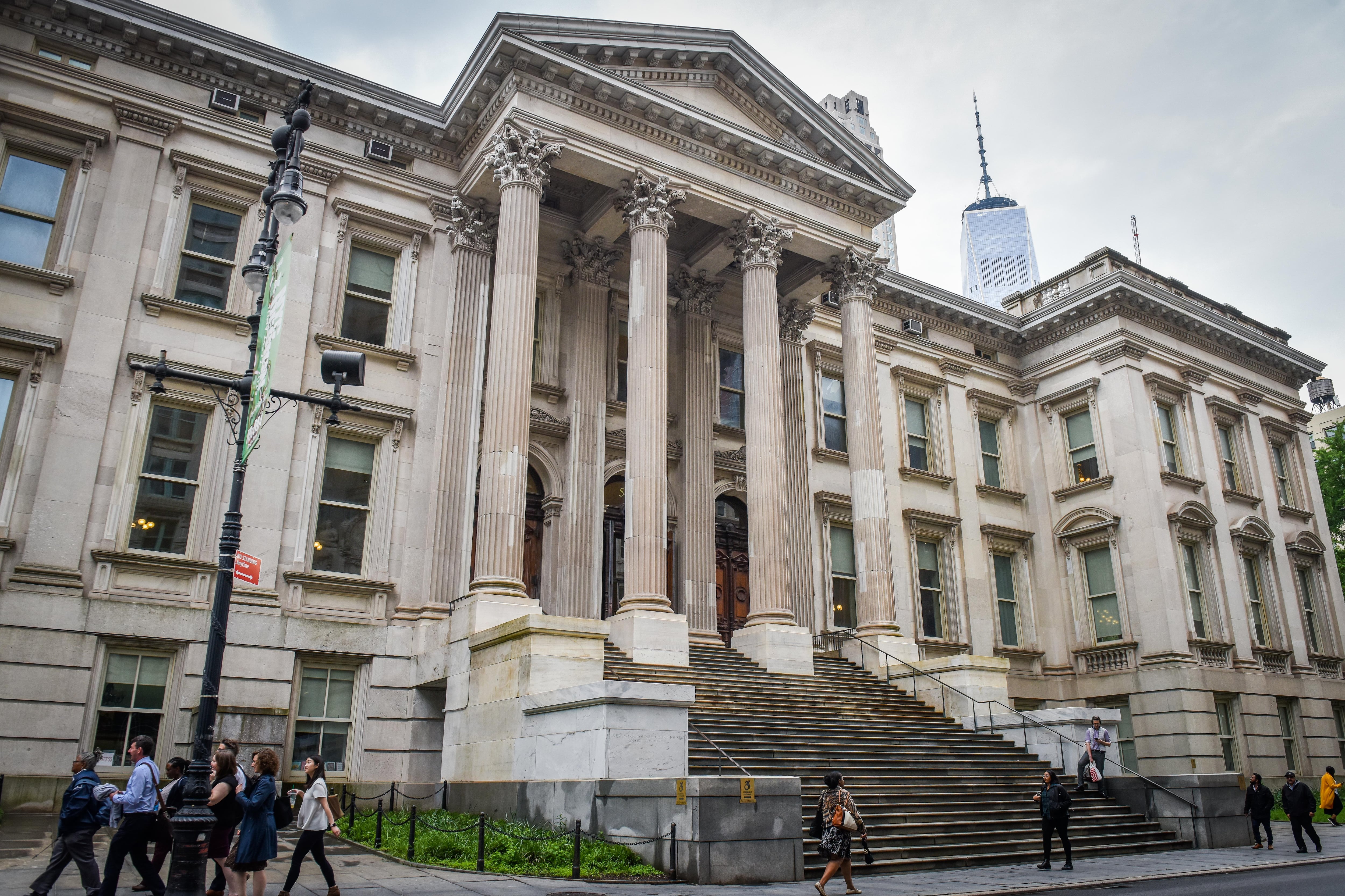 The exterior of a large white building with columns and steps.