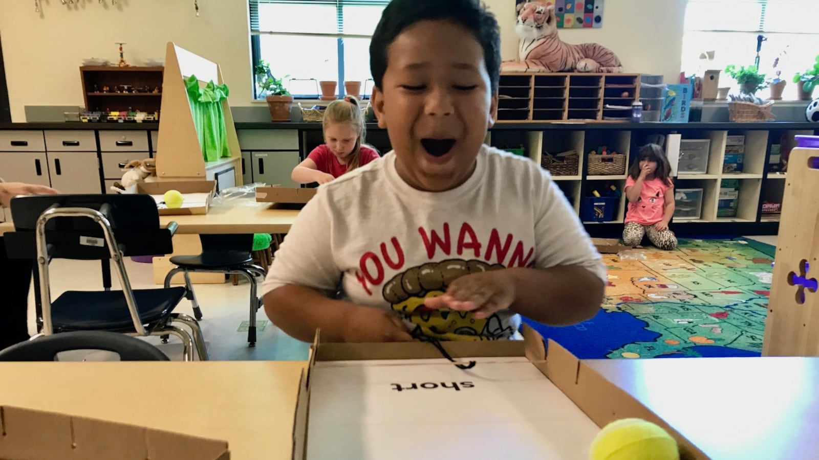 Malachi Ballinger, 6, laughs at how far he has made his “pinball” travel during a science lesson in his kindergarten classroom in Redmond, Oregon.