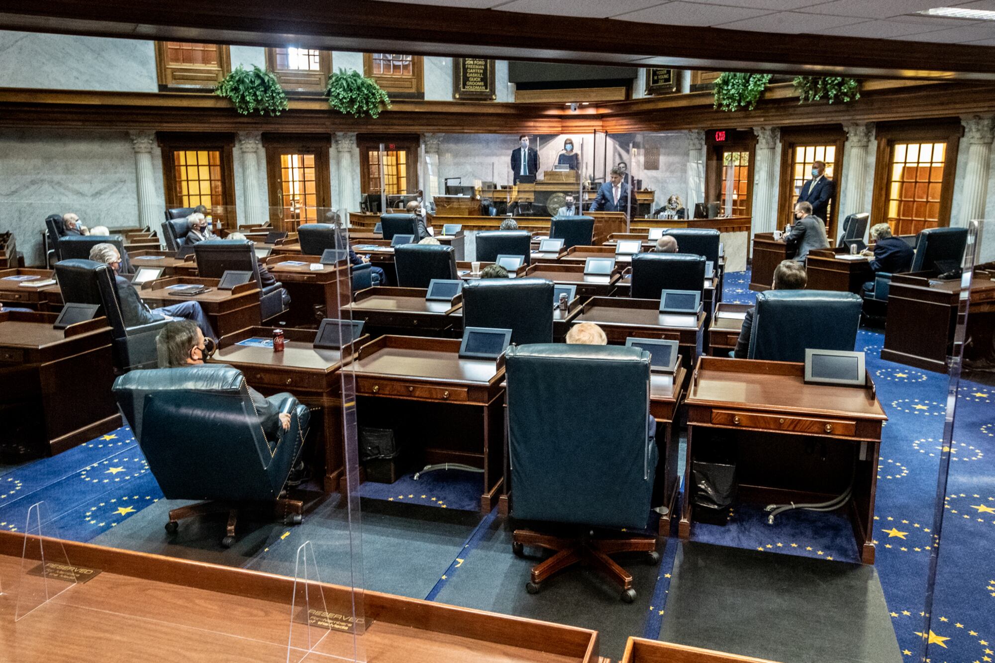 Lawmakers socially distance using the floor and balcony in the Indiana Senate chamber on Organization Day at the Indiana Statehouse in 2020.