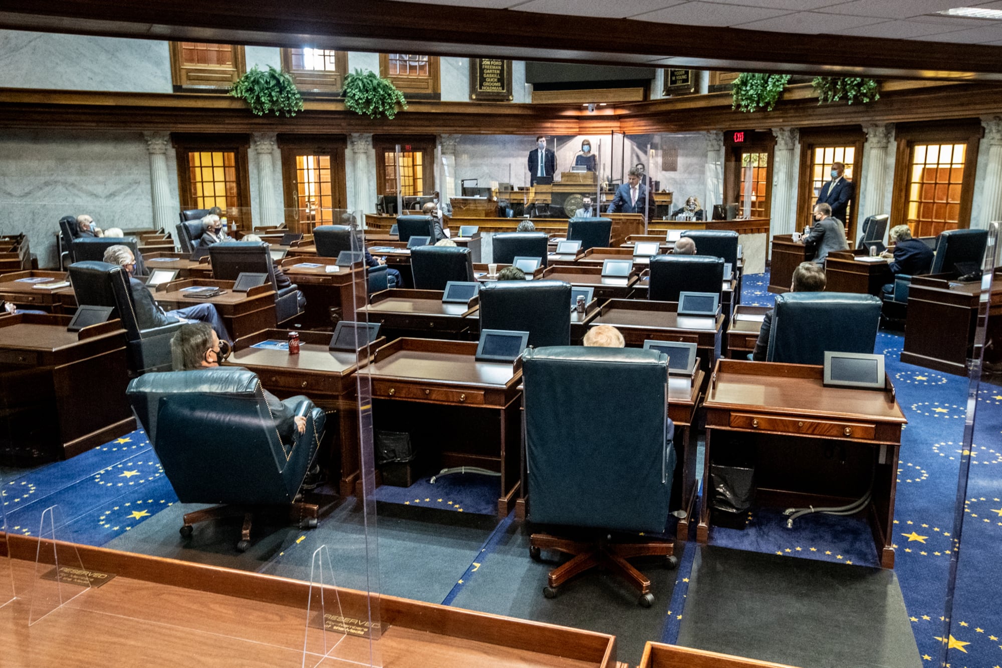 Lawmakers socially distance using the floor and balcony in the Indiana Senate chamber on Organization Day at the Indiana Statehouse in 2020. 
