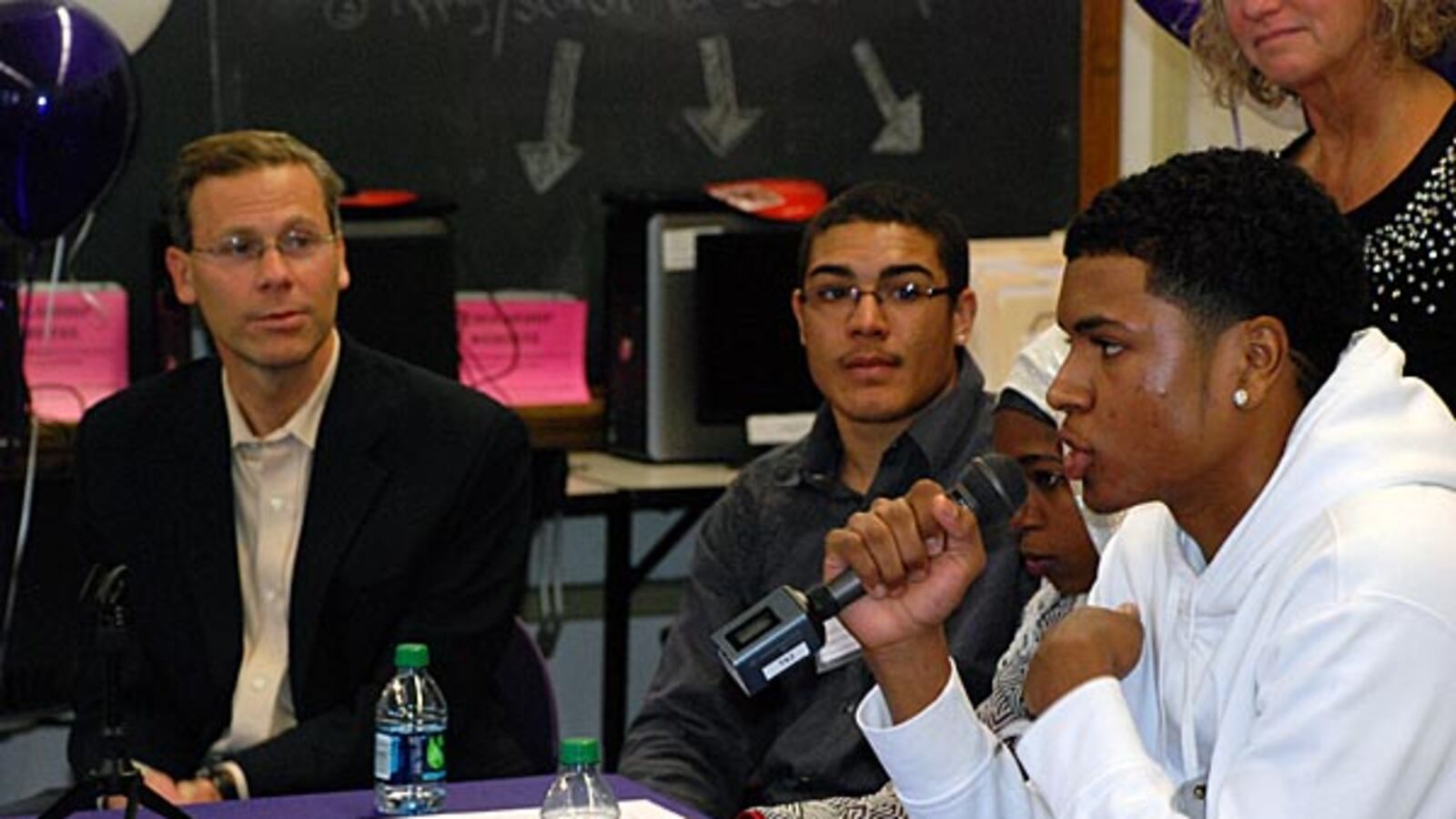 DPS Superintendent Tom Boasberg looks on as students at South High School discuss their school's jump in 2013 graduation rate.