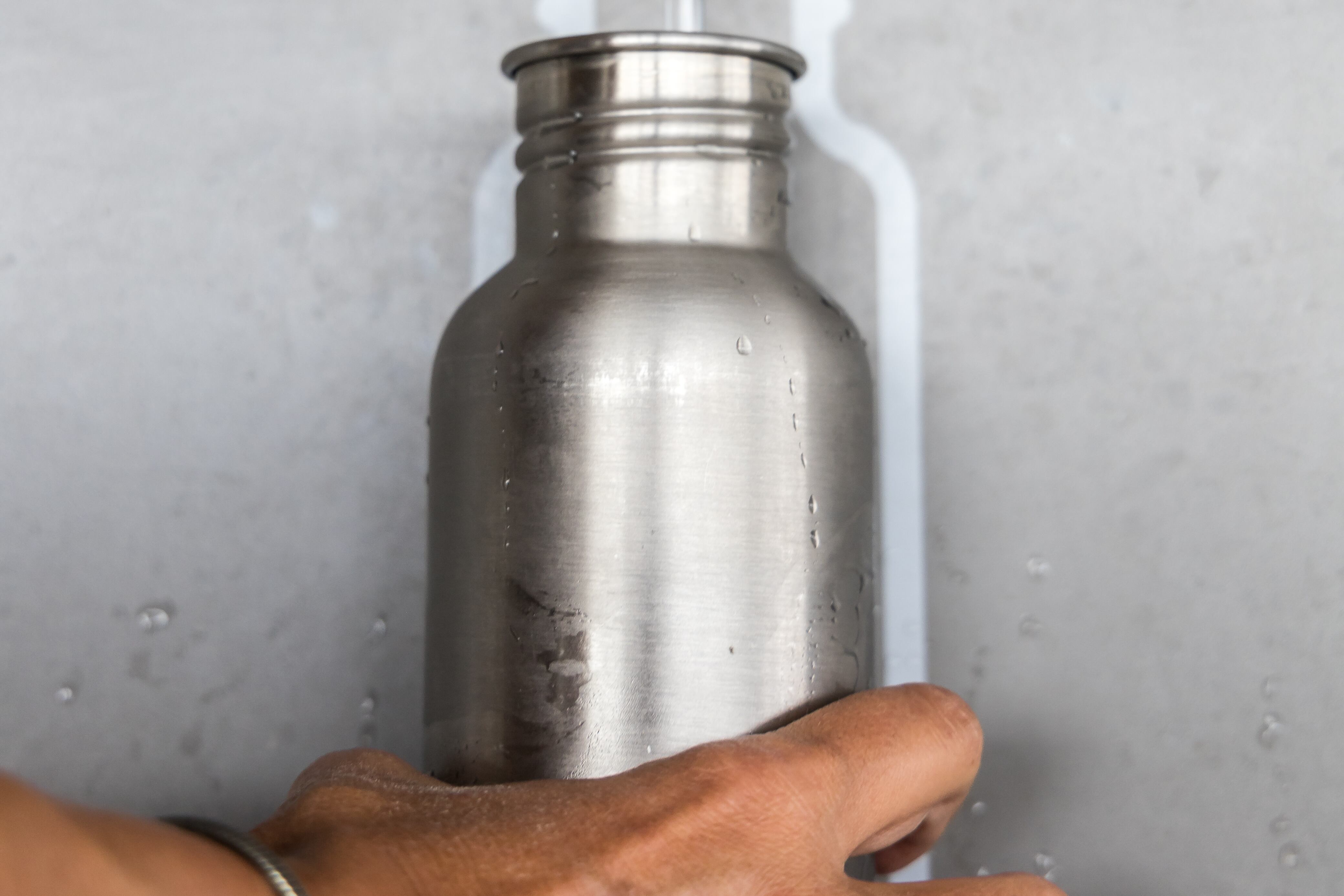 A person fills a water bottle