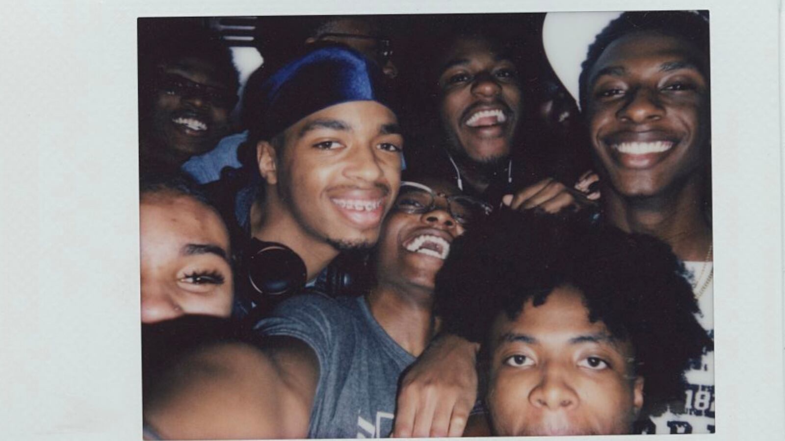 A group of teens smile for a selfie.