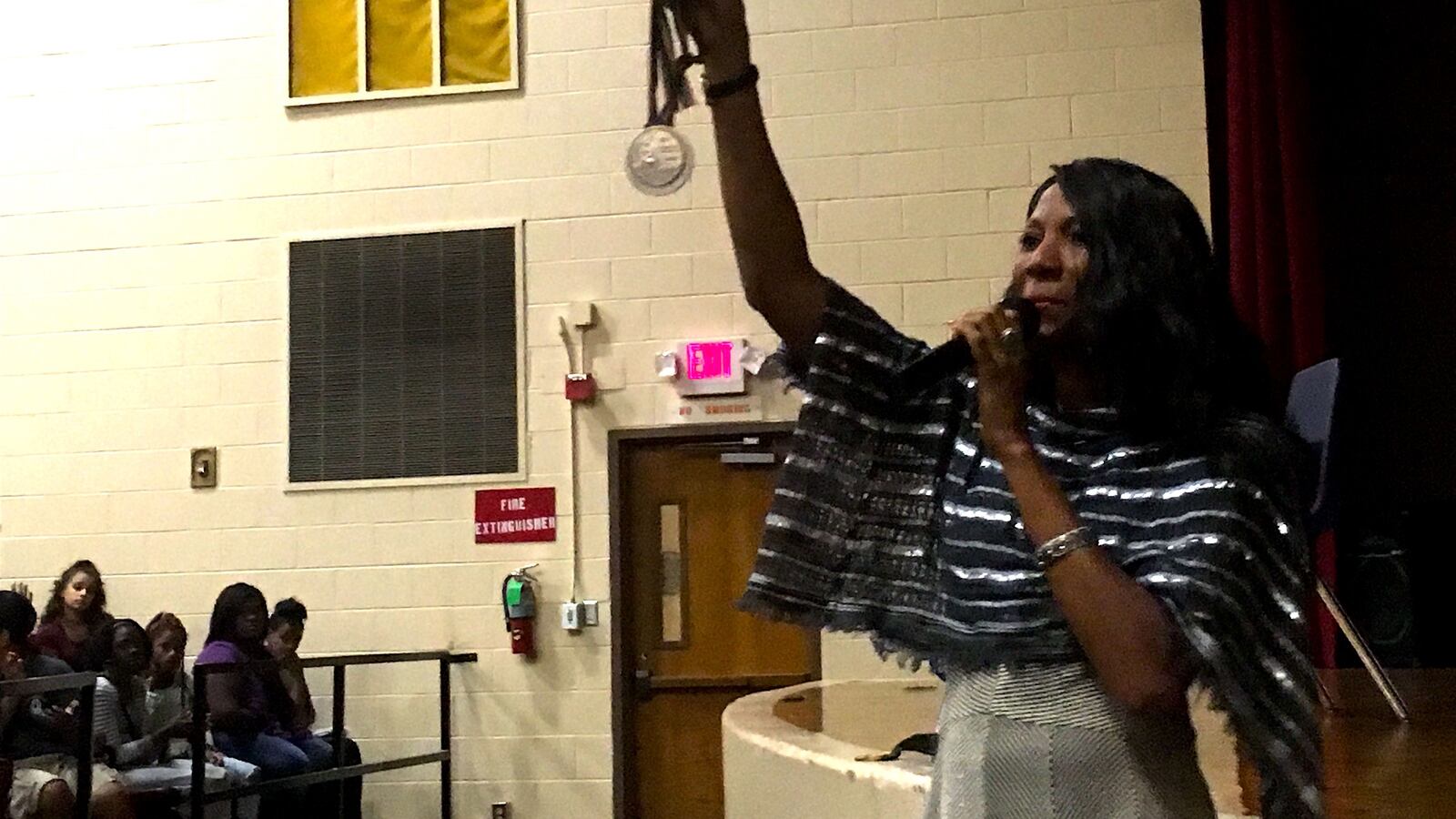 Olympic gold medalist and Memphis native Rochelle Stevens shows one of her medals to students at newly reopened Memphis Scholars Raleigh-Egypt.