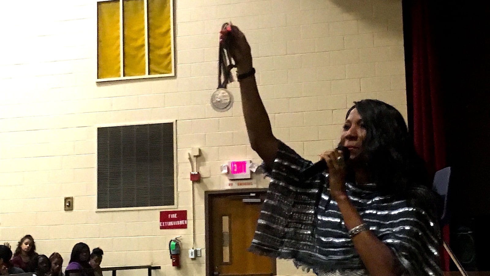 Olympic gold medalist and Memphis native Rochelle Stevens shows one of her medals to students at newly reopened Memphis Scholars Raleigh-Egypt.