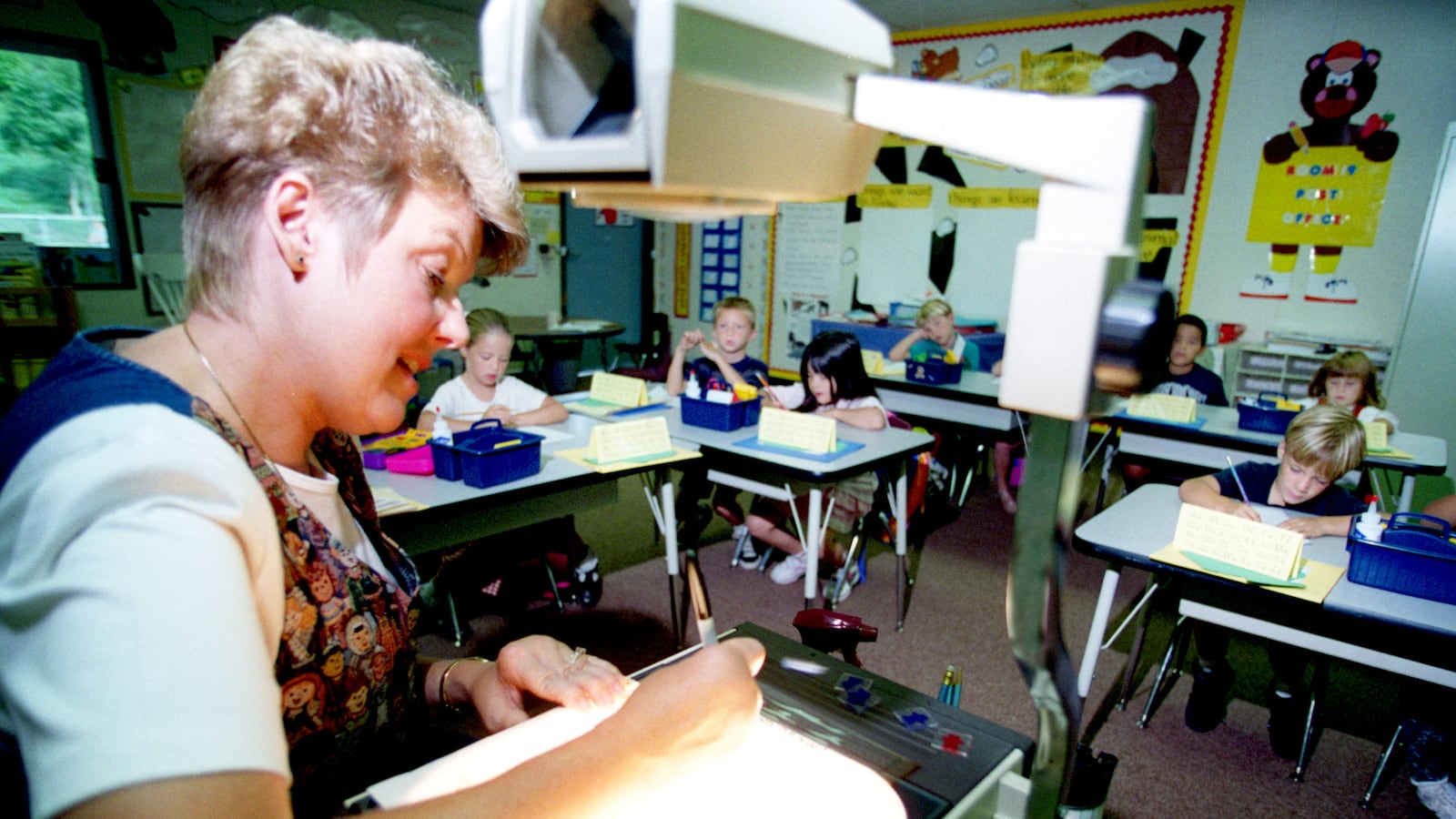 At Foxborough Elementary School, in 1996, 1st grade teacher Linda Kiefer uses a projector to show her students the formation of numbers. The Capistrano Unified School District was one of the first in Orange County, California to implement a class-size reduction plan after a state funding bill was signed.