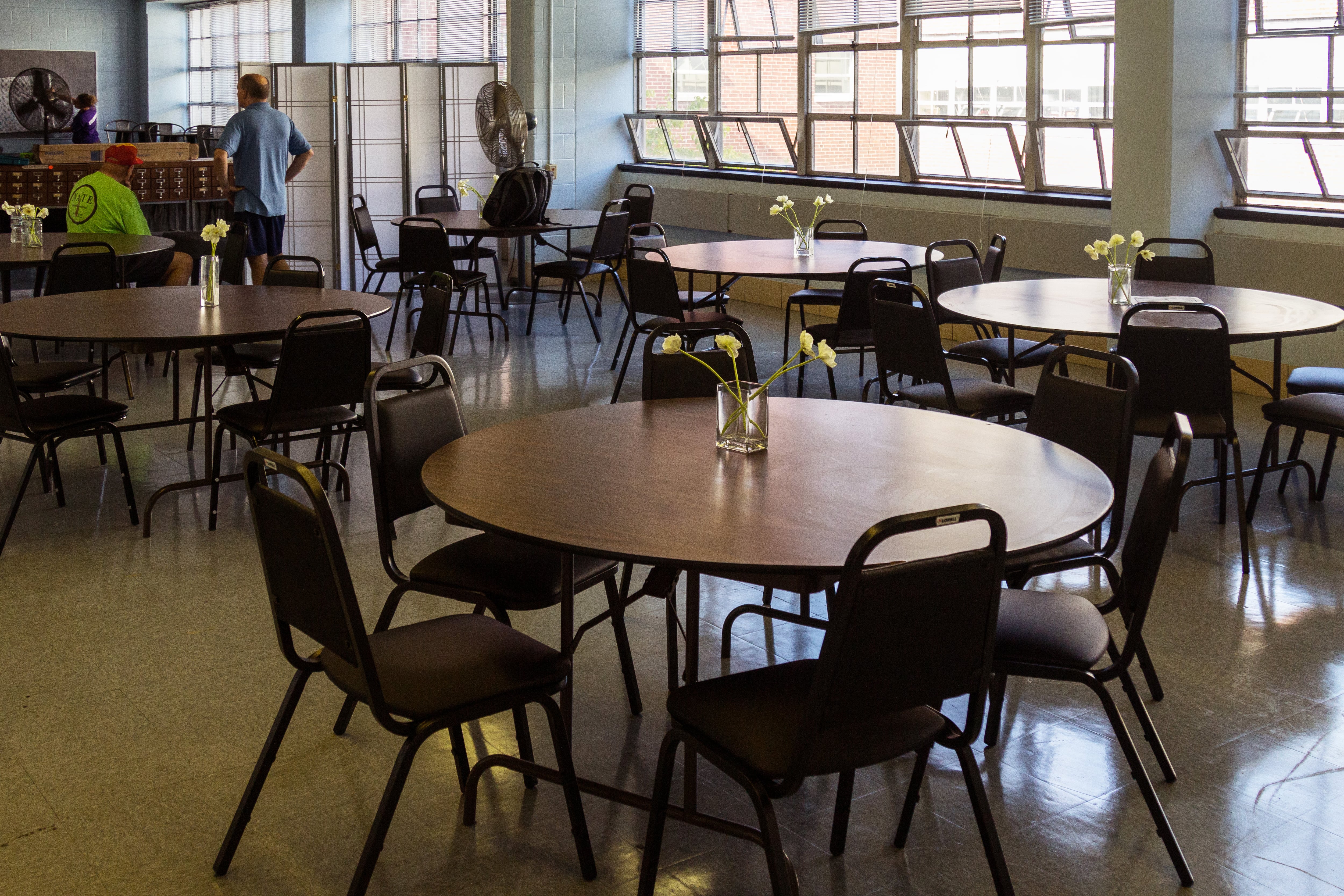 Empty tables and chairs in a teacher’s lounge.