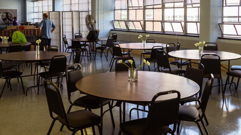 Empty tables and chairs in a teacher’s lounge.