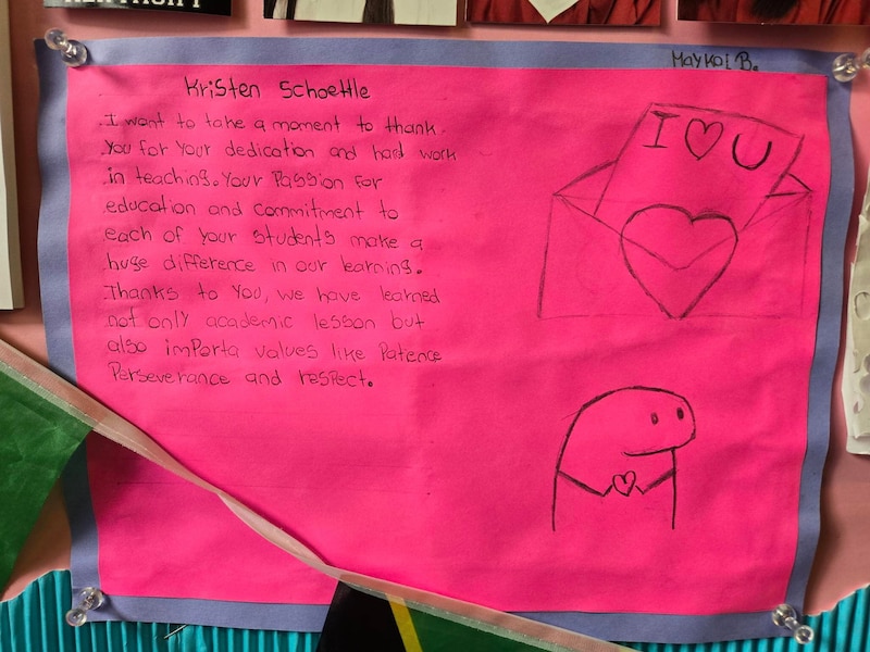Handwriting on pink paper with a drawing.