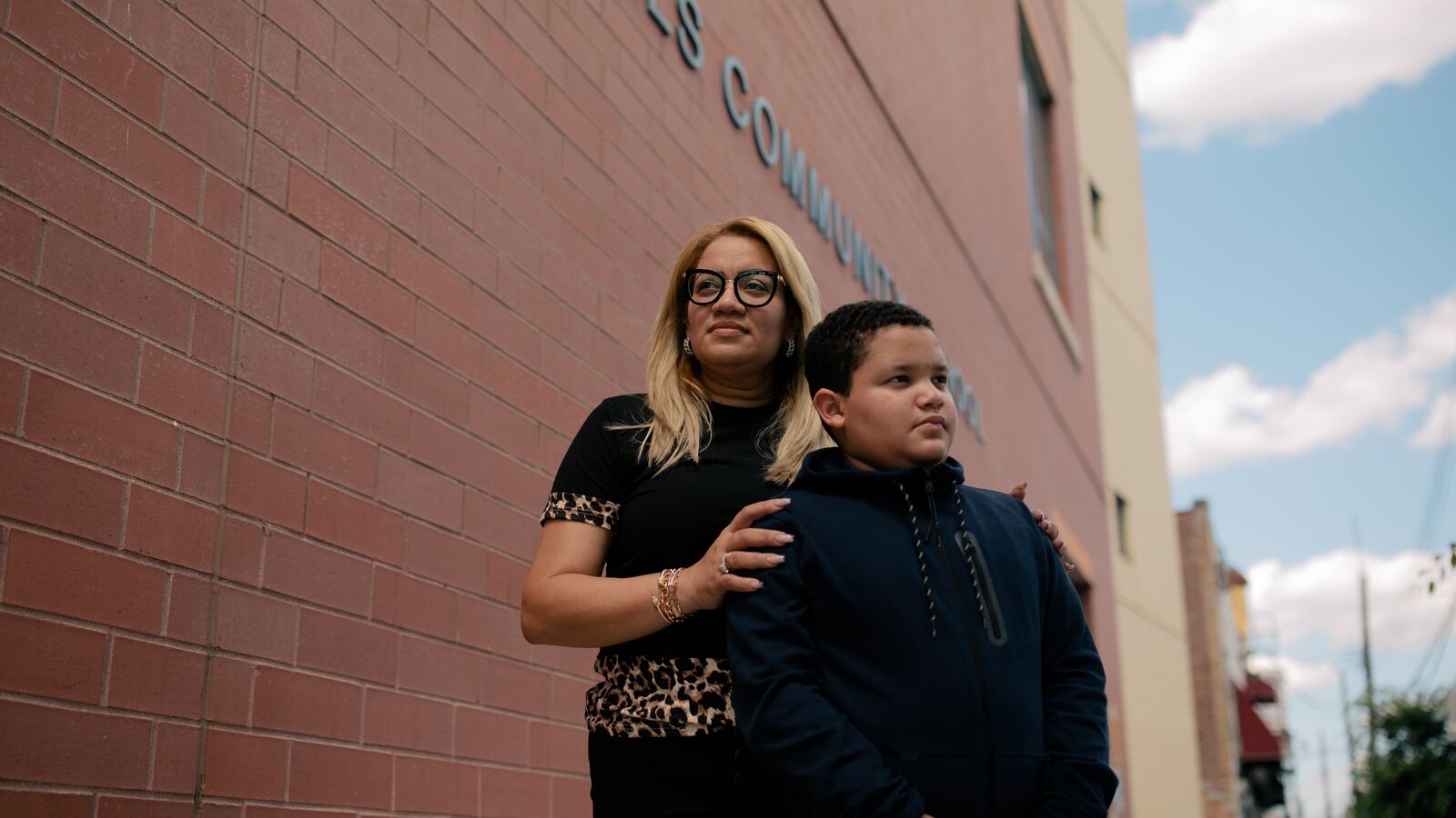 Milagros Reyes stands outside of the red-brick facade of P.S. 89 with her son, fifth grader José, on a beautiful June afternoon.