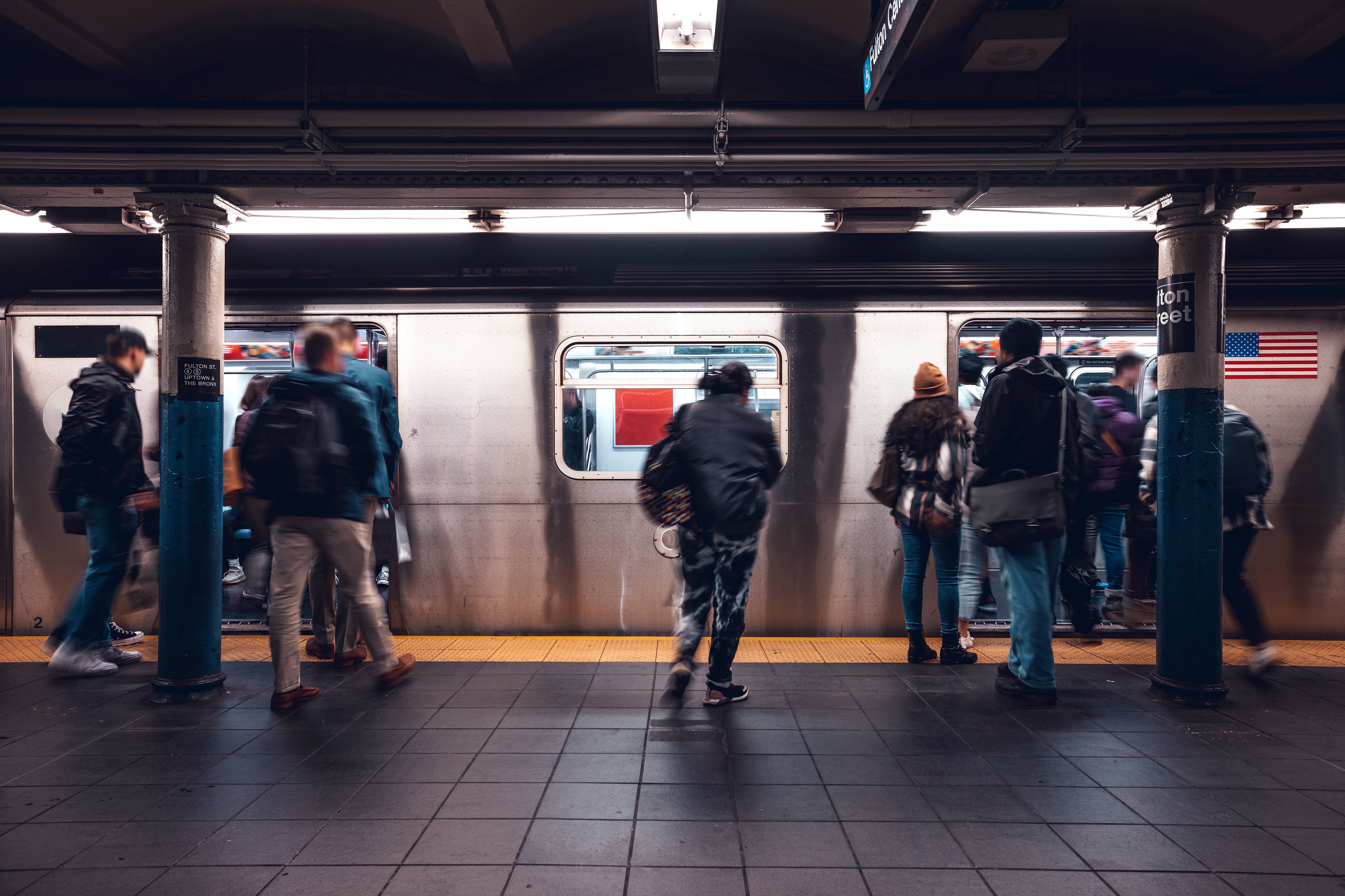 Crowd of people in a NYC subway station waiting for the train.