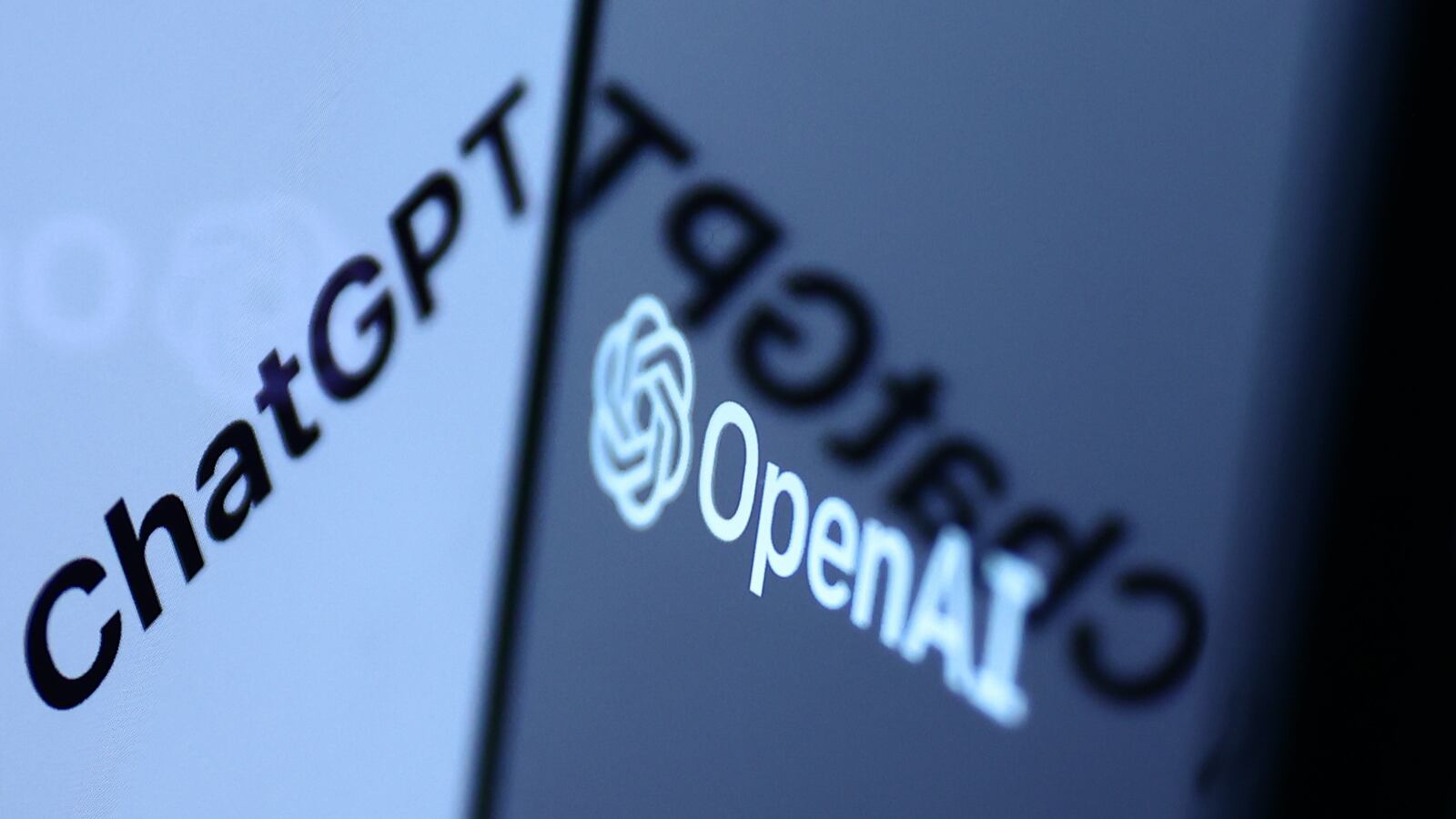 ChatGPT sign in the website displayed on a laptop screen and OpenAI logo displayed on a phone screen.