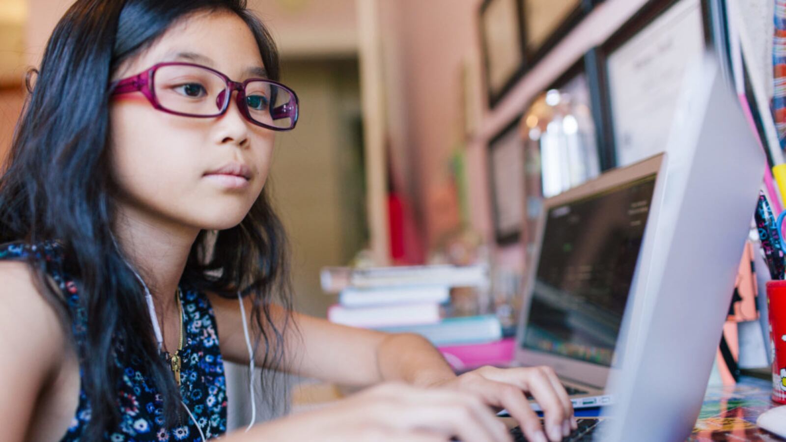 Young girl sitting in front of laptop
