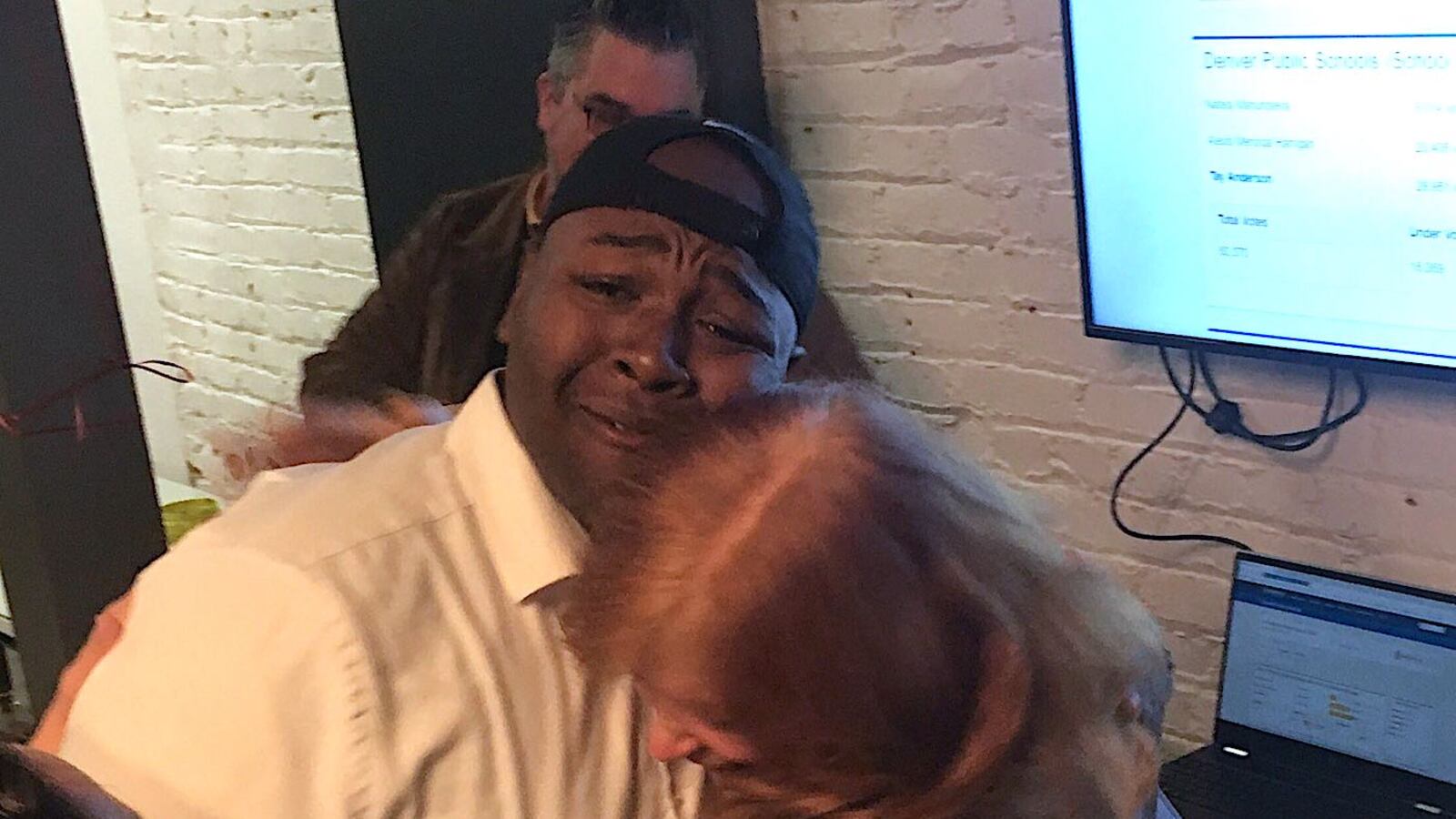 Tay Anderson hugs a supporter as early returns show him leading in the race for an at-large  Denver school board seat.
