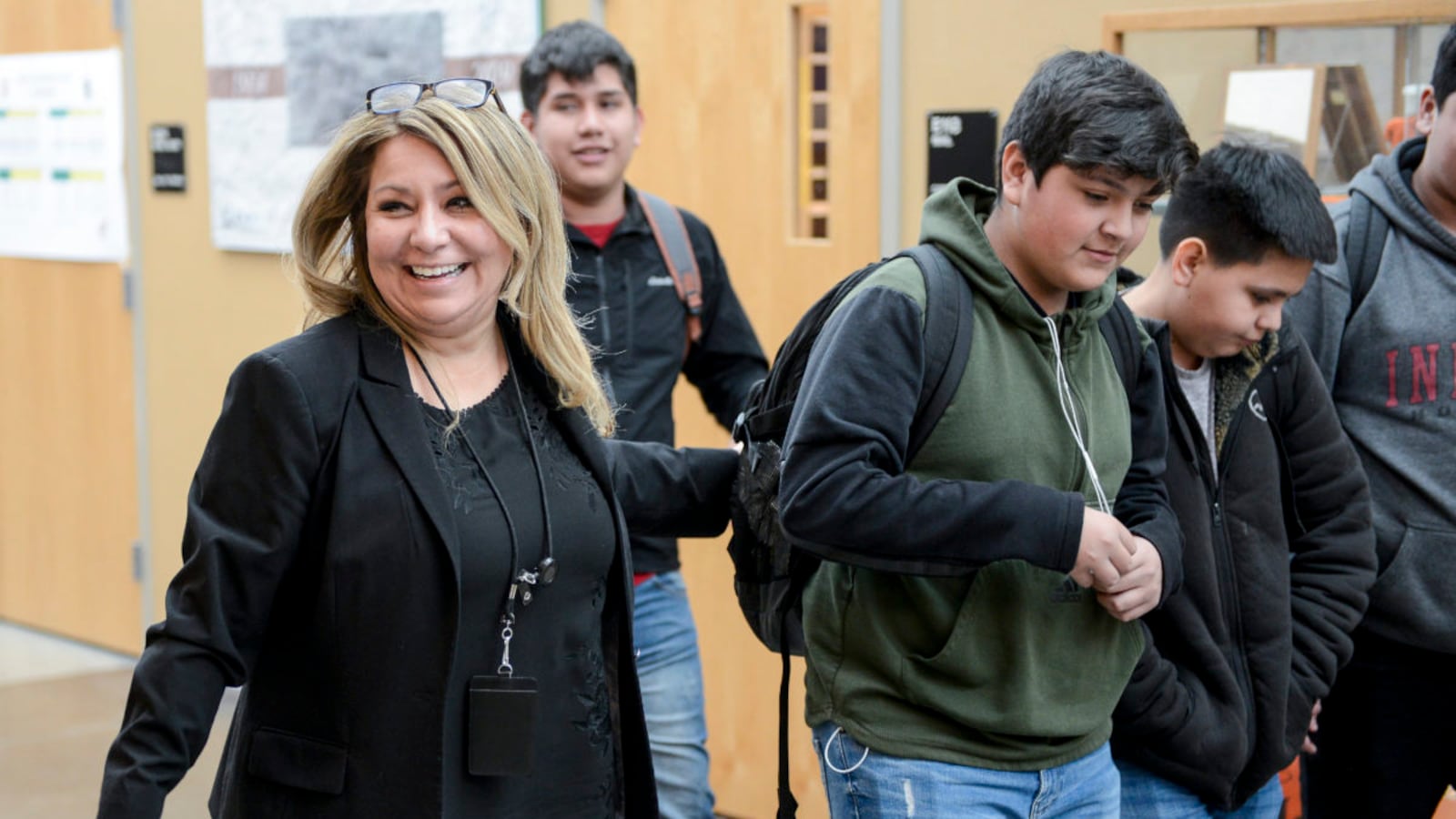 Adams City High School principal Gabriella Maldonado jokes with students in the hallway Monday, Feb. 4, 2019 in Commerce City, Colorado.