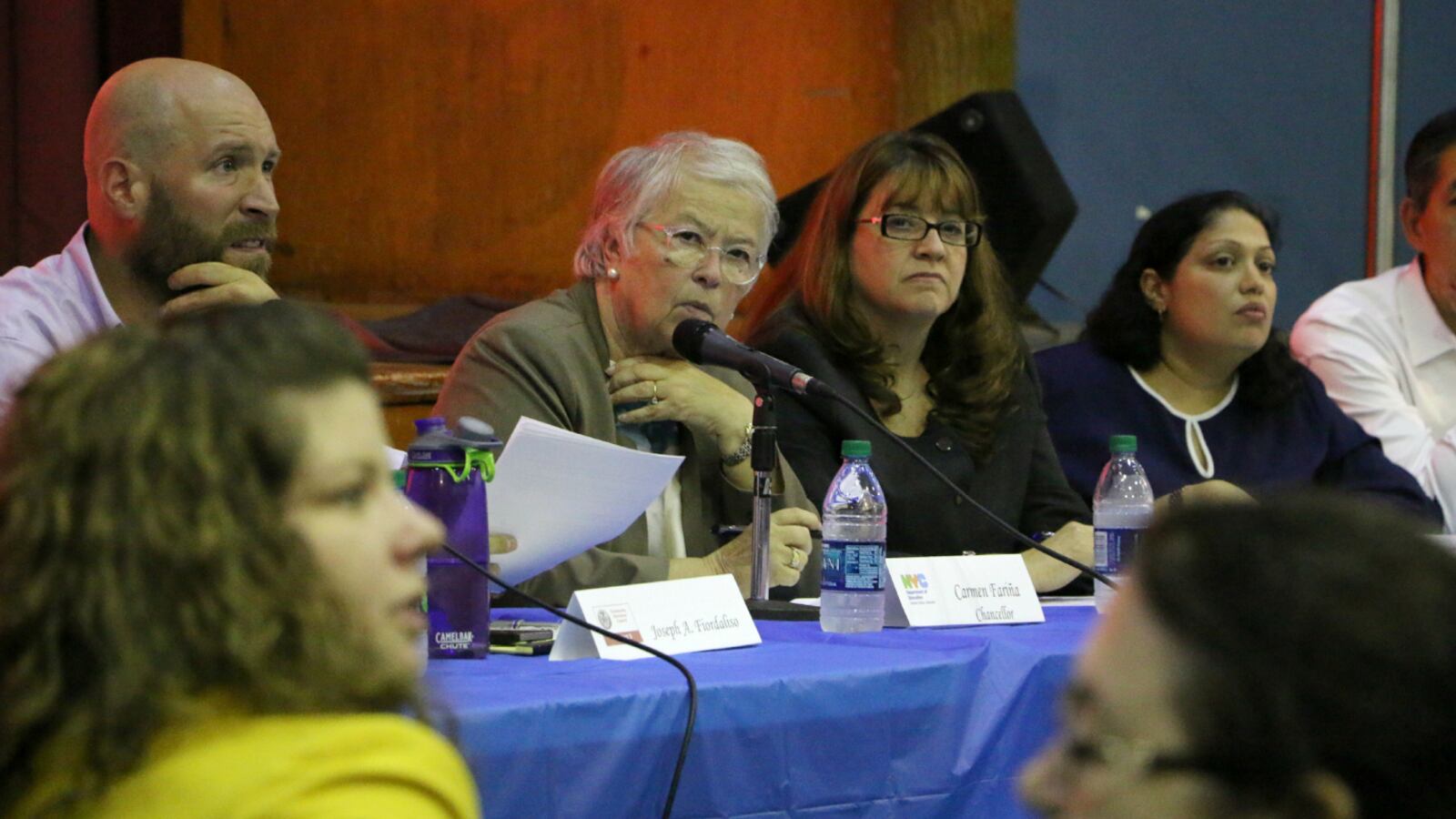 Chancellor Fariña spoke about school diversity at a town hall in District 3 in 2015. She is seated next to Superintendent Ilene Altschul, second from right.