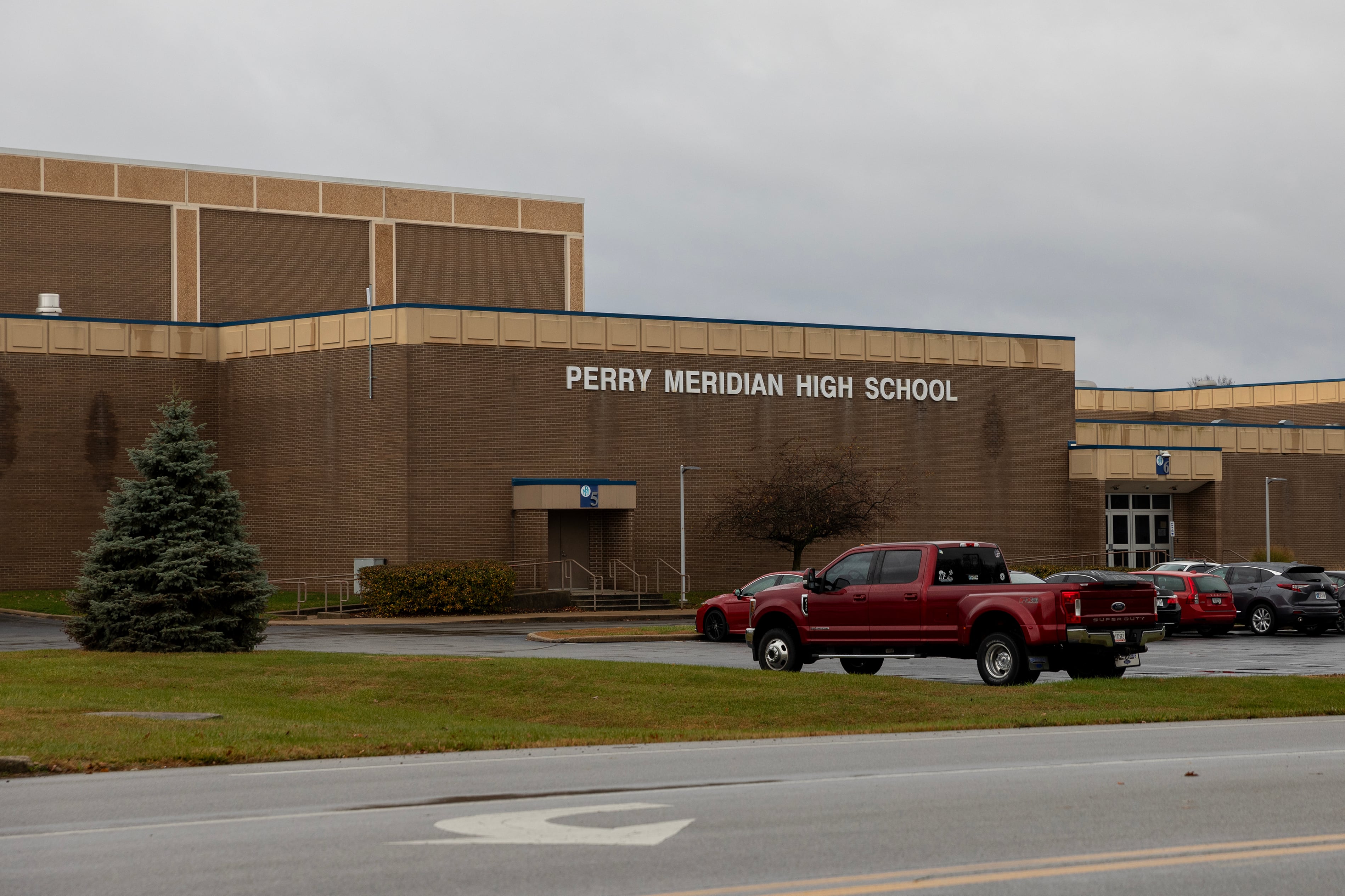The front entrance to a large school building on a cloudy day.