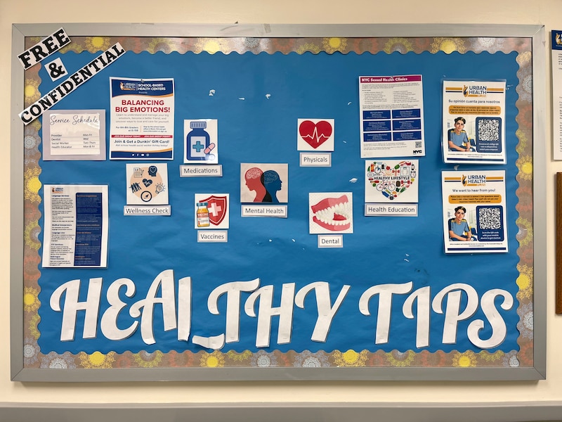 A poster board hangs on the wall with large white letters that spell "Health Tips."