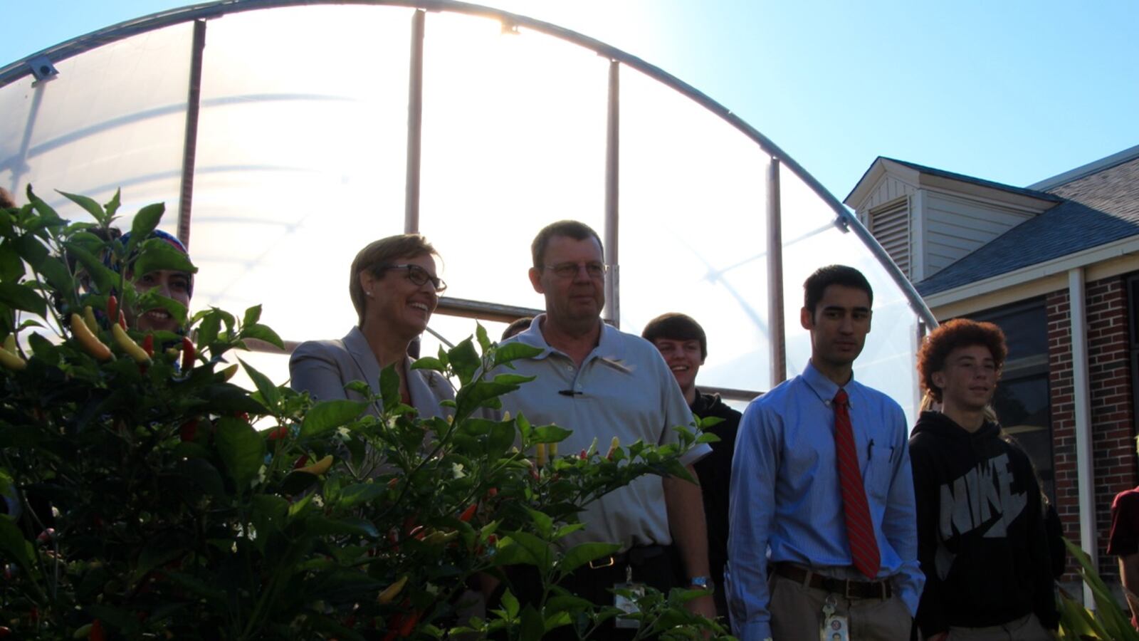 Katie Wilson of the U.S. Department of Agriculture admires Kingsbury High School's edible garden while touring the Memphis school with teachers and students.