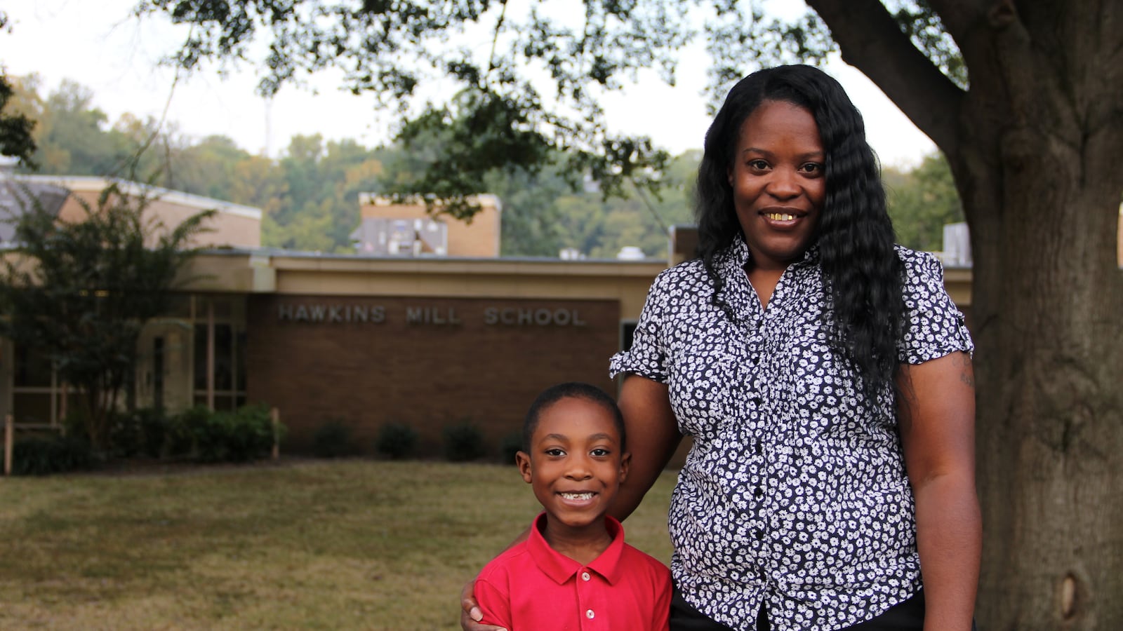 Alicia Tomlinson stands with her son, Jacobi, outside of Hawkins Mill Elementary School, where Jacobi is in the first grade. Tomlinson has applied to serve on her school's neighborhood advisory council.
