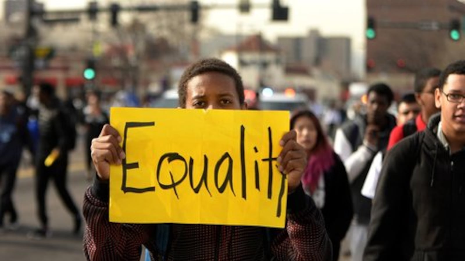 A student marches down Colfax Avenue in Denver in 2014.