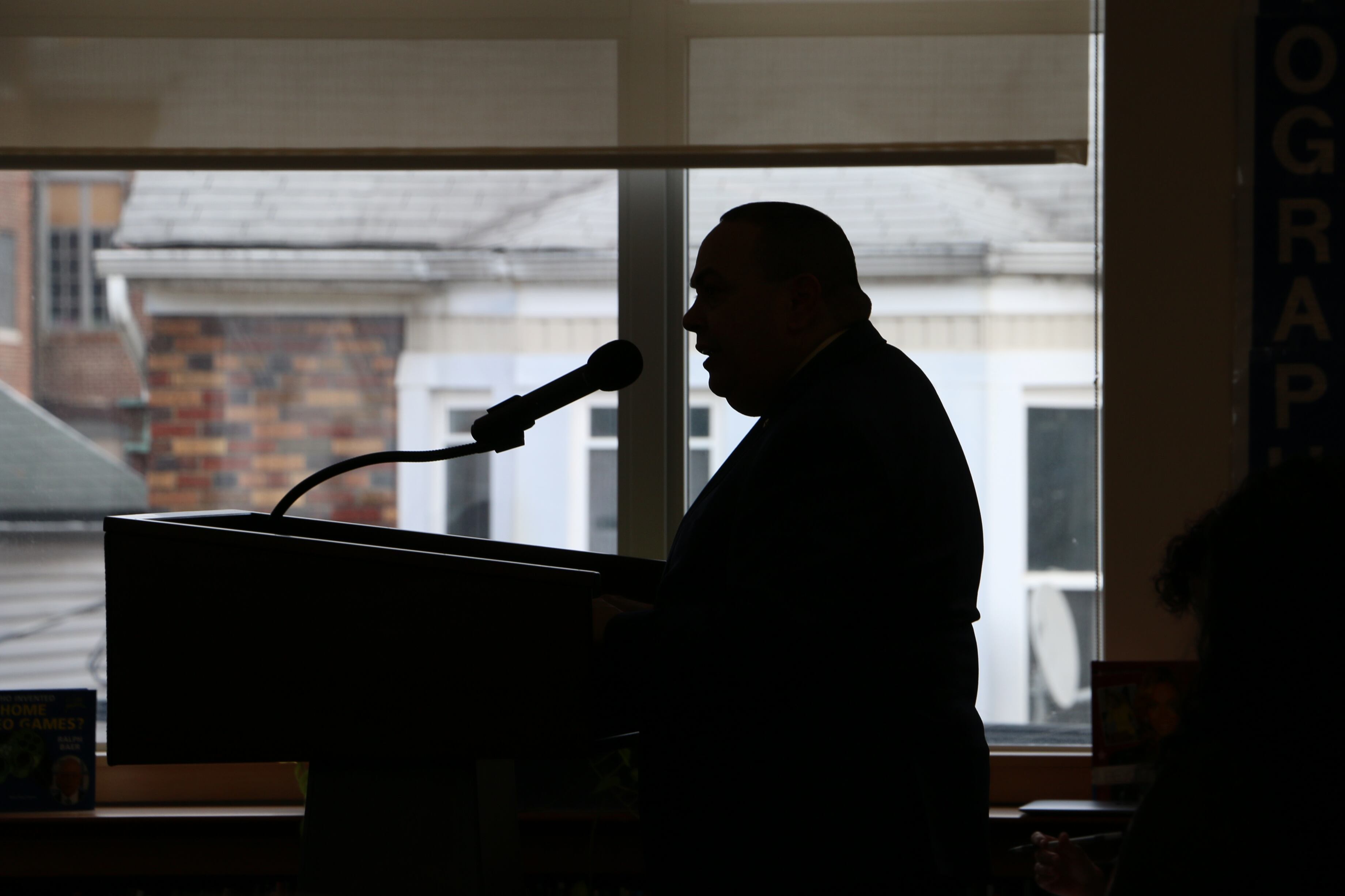 A silhouette of Newark schools Superintendent Roger León speaking into a microphone on March 29, 2022.