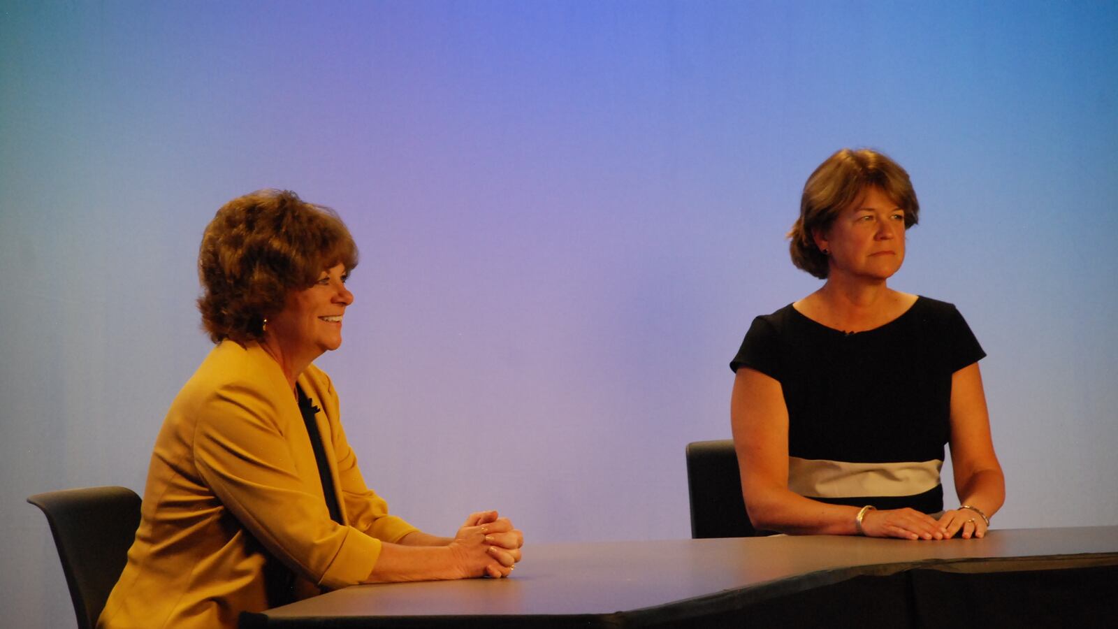 Denver school board candidate Kristi Butkovich and incumbent Anne Rowe wait for a televised debate to begin.