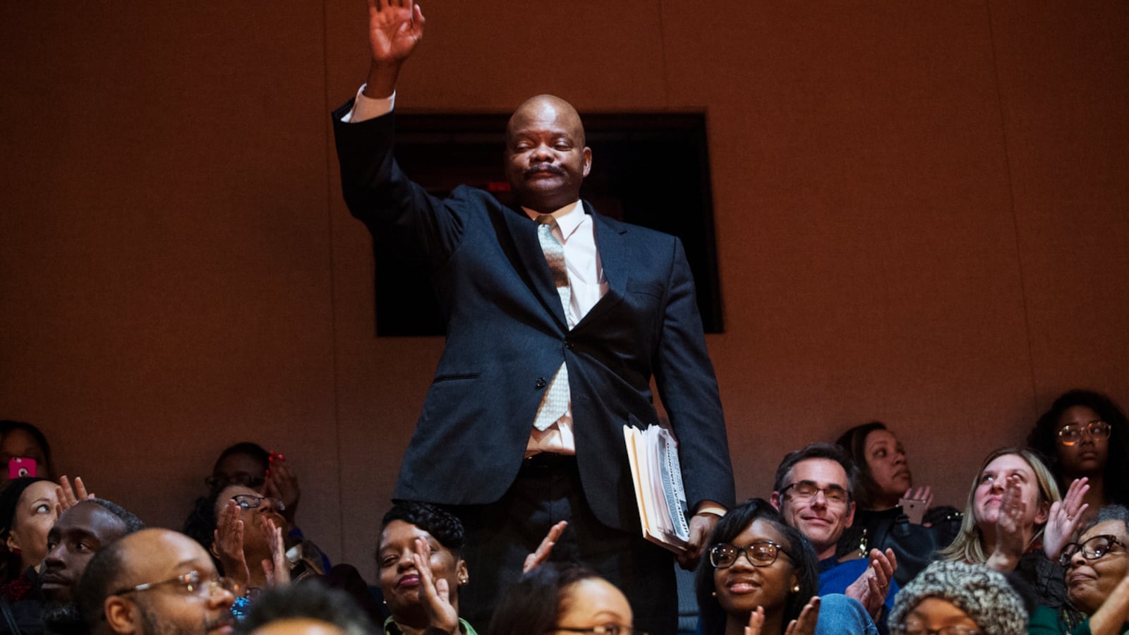 Detroit Board of Education member LaMar Lemmons waves to the audience during "School Days," an evening of storytelling focused on the Detroit Public Schools hosted by Chalkbeat Detroit and The Secret Society of Twisted Storytellers in March 2017