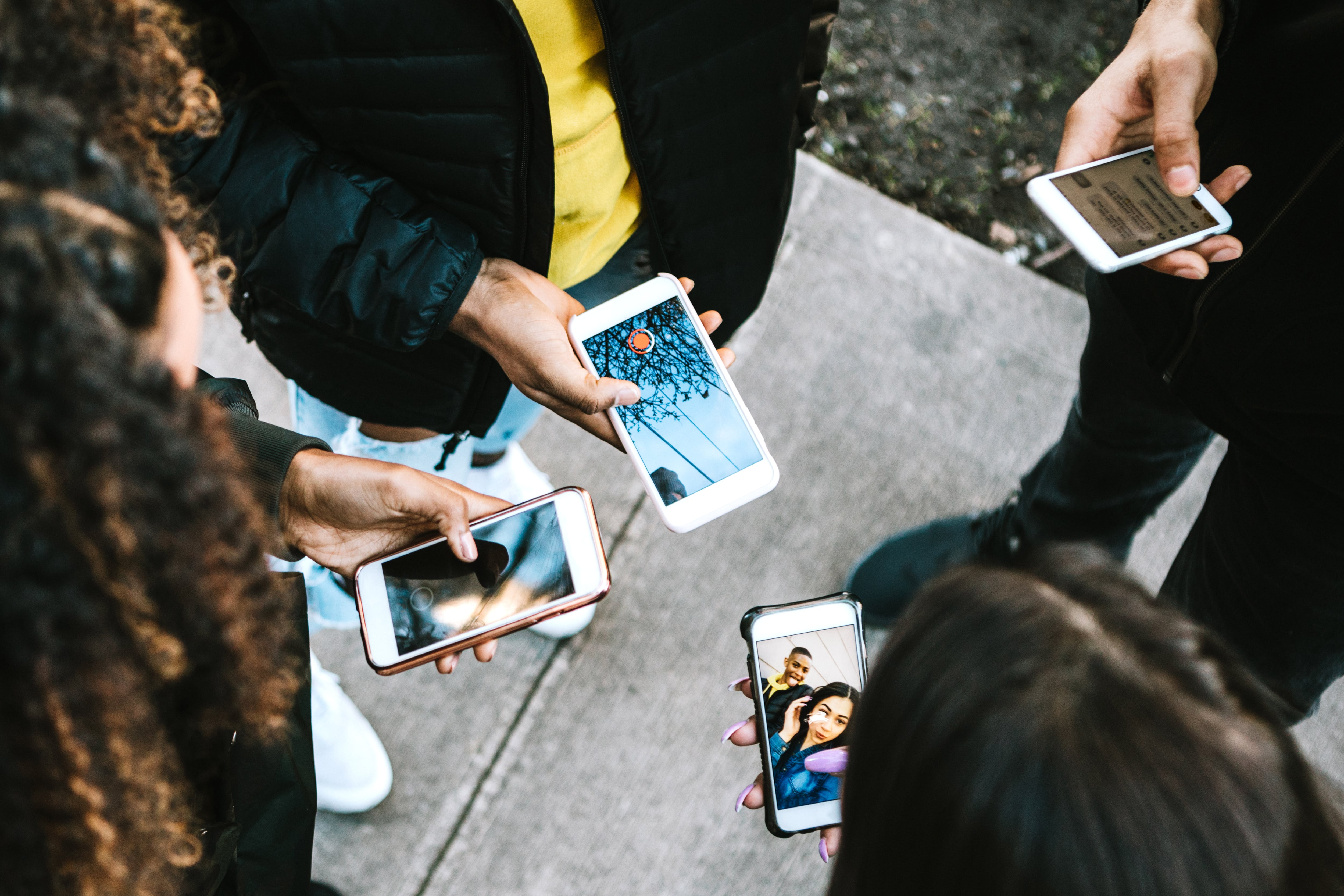 Students hold cell phones.