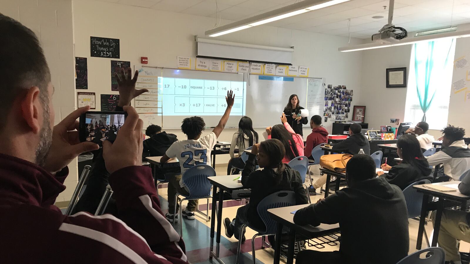 Mumford Academyprincipal Nir Saar, left, records video of a lesson taught by Algebra II teacher Lindsey Aldridge as part of a new effort to build a video catalog that he can use to train teachers — a technique he's expanding under the guidance of school leadership coaches.