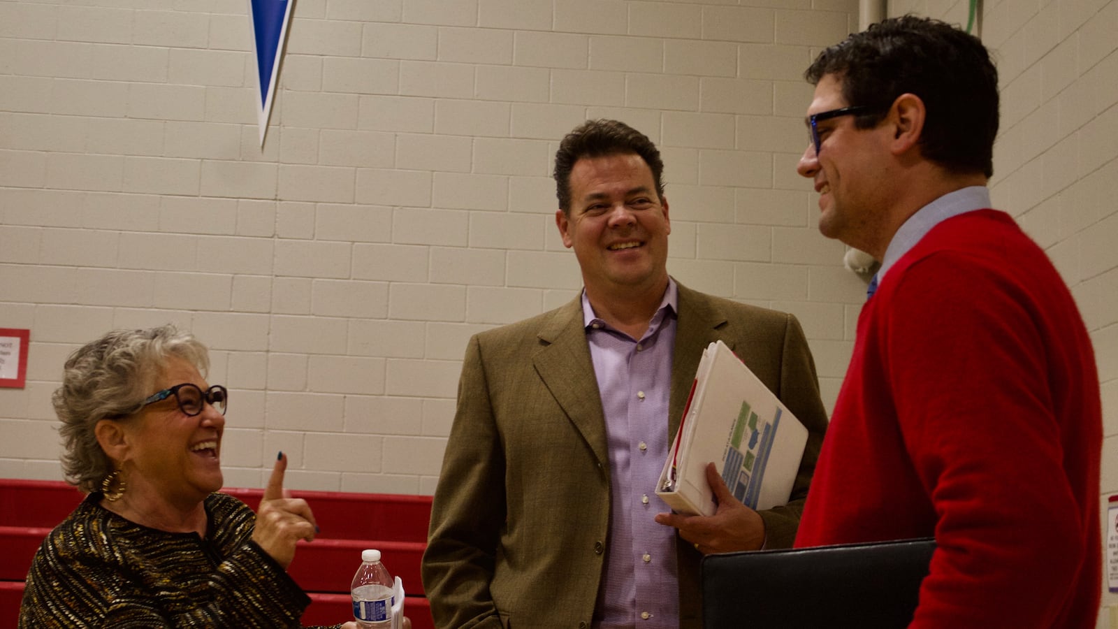 Douglas County school board candidates Chris Schor, left, Grant Nelson and Ryan Abresch chat before a candidate forum. Schor is a member of the "CommUnity Matters" slate, while Nelson and Abresch are members of the "Elevate Douglas County" slate. (Photo by Nic Garcia)