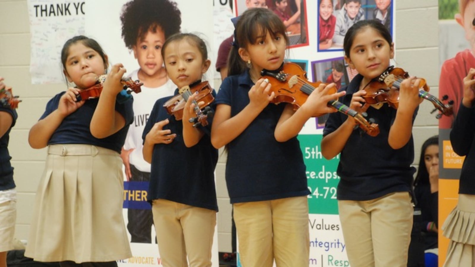 Swansea Elementary students play violins before the grant was announced.