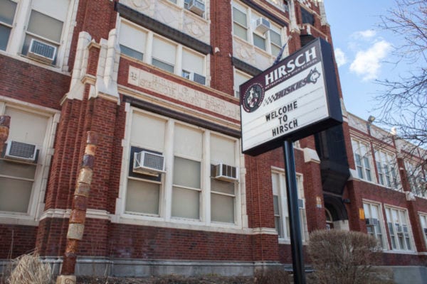 A sign in front of a school facade says “Welcome to Hirsch.”