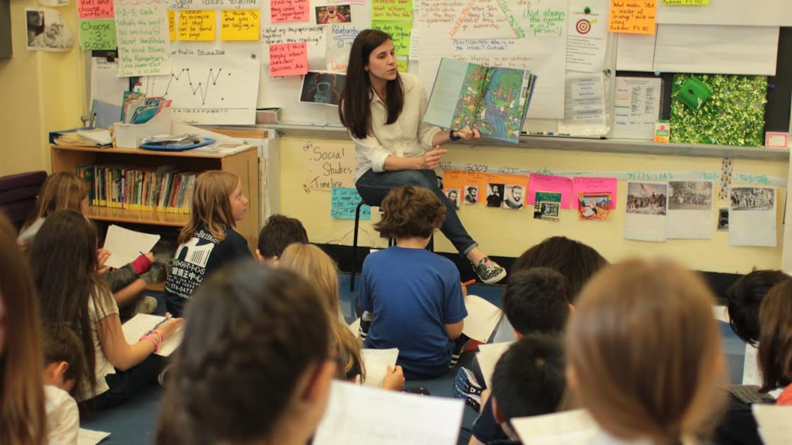 Lauren Bakian Aaker reads aloud to her fourth-grade students.