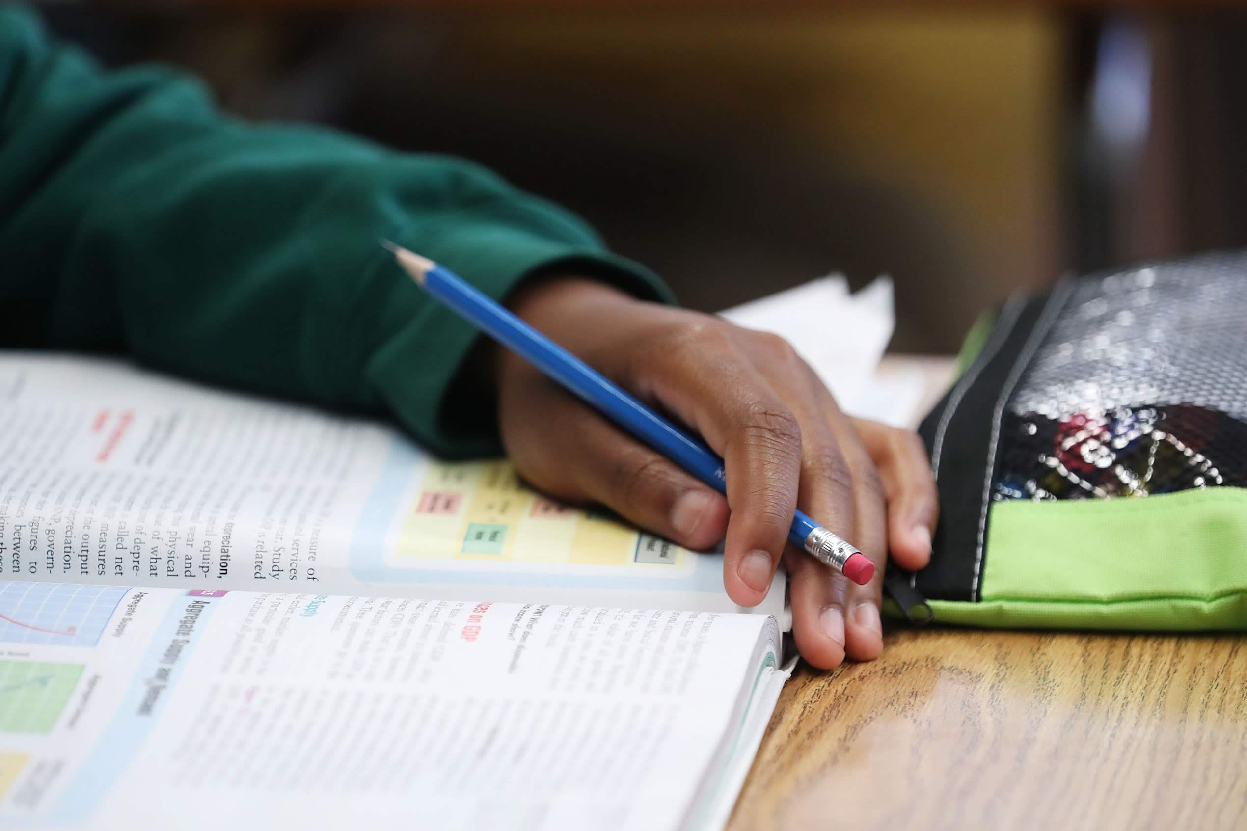 Male student in classroom, working at desk in Hillcrest High School in Memphis, Tennessee. —April, 2019— Photo by Karen Pulfer Focht/Chalkbeat