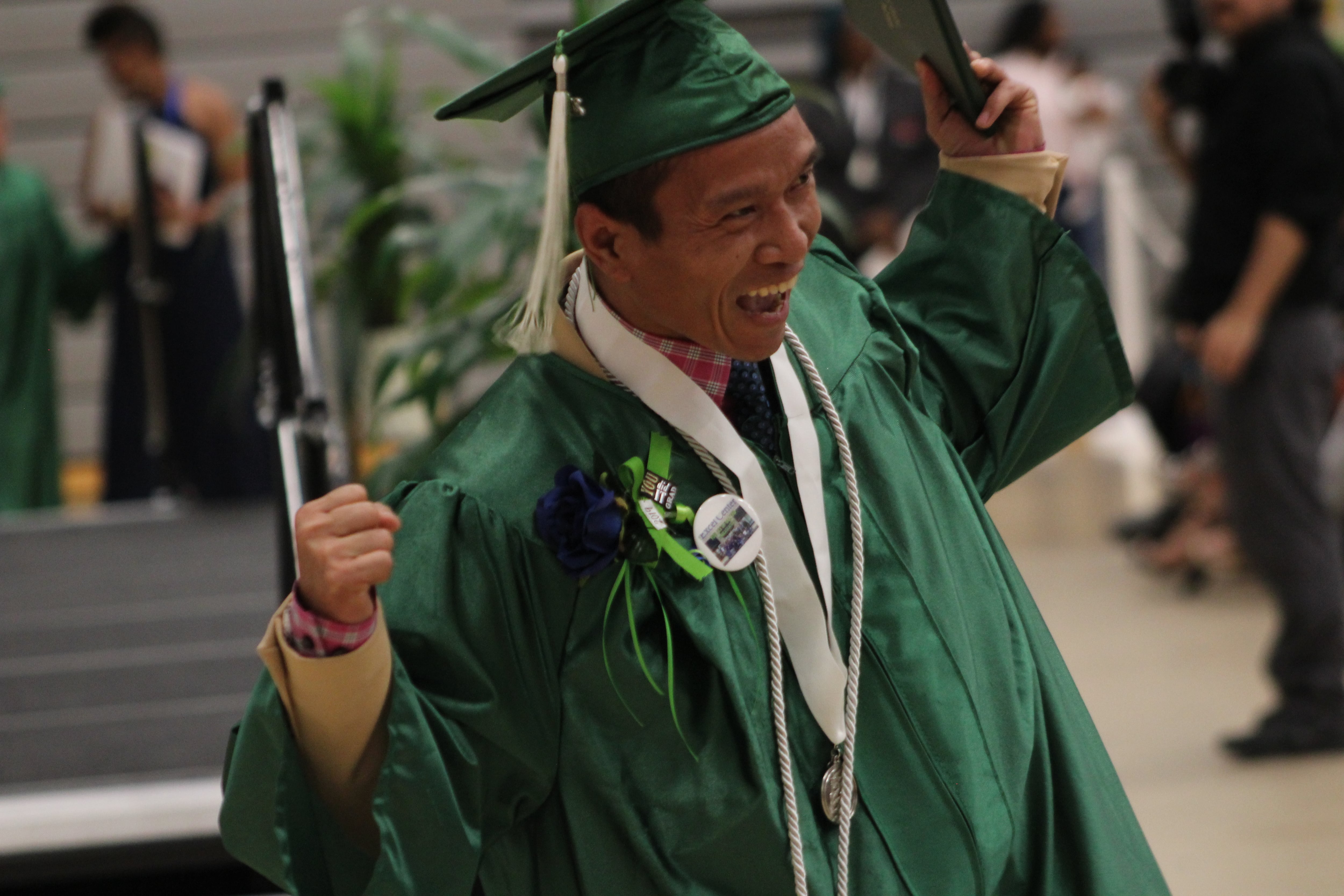 An Excel Center graduate celebrates after crossing the stage at a ceremony Thursday night.