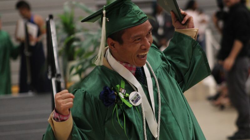 An Excel Center graduate celebrates after crossing the stage at a ceremony Thursday night.