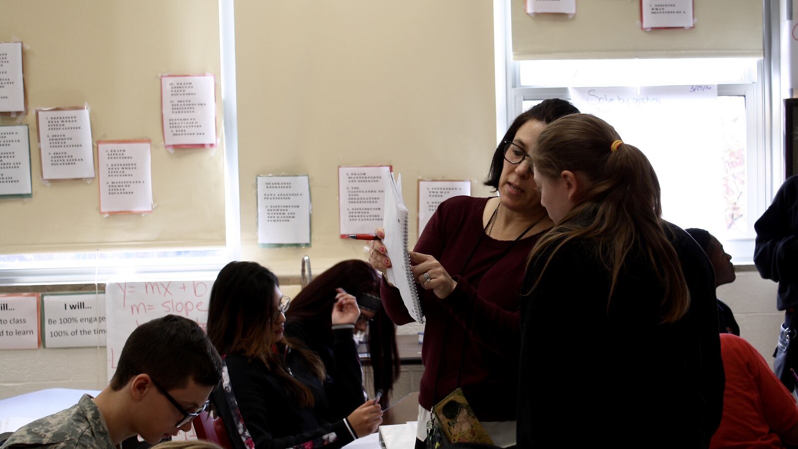 Robin Clark, a math teacher at Manual High School, goes over an assignment with a student.
