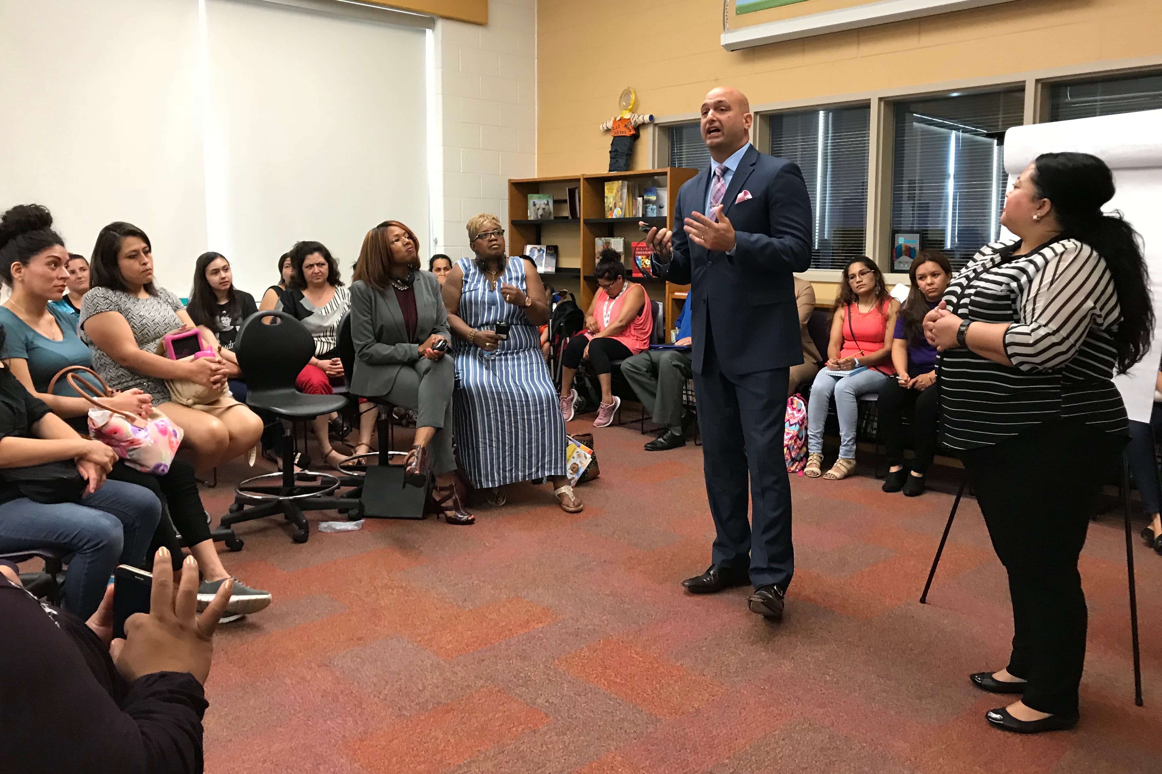 Detroit schools superintendent Nikolai Vitti addresses Spanish-speaking parents during a forum at Munger Elementary-Middle School.