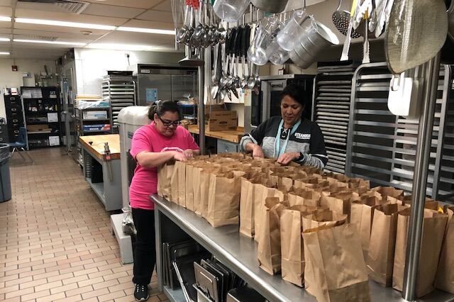 Sheridan staff prepare grab-and-go meals for students during school closures.